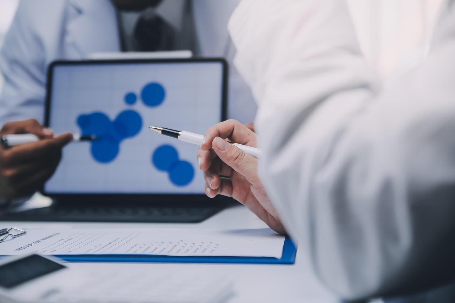 Meeting, tablet and team of doctors with collaboration for healthcare talk and telehealth app in office. Surgeon group, tech and medical discussion with website for hospital funding or sponsorship photo