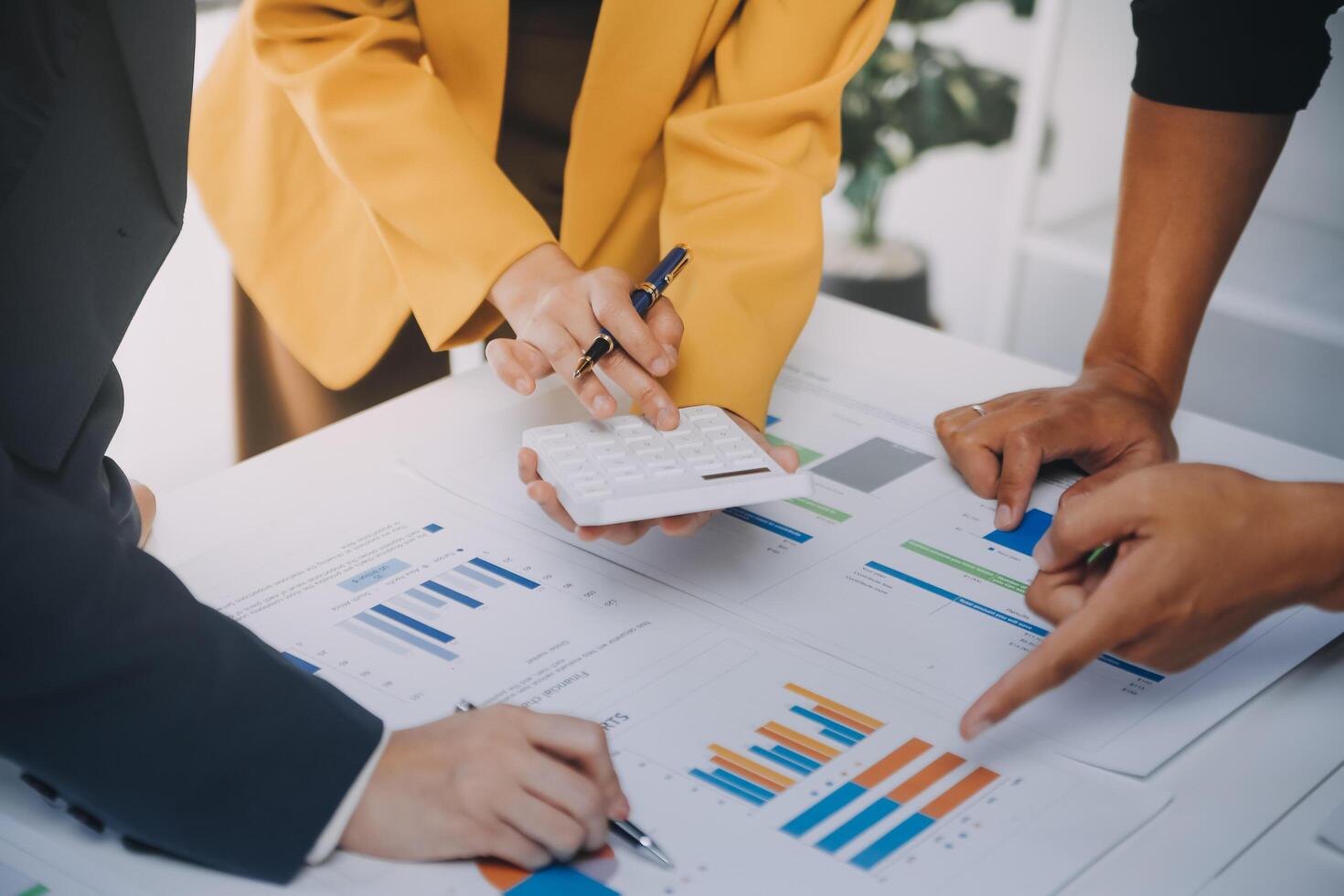 Financial analysts analyze business financial reports on a digital tablet planning investment project during a discussion at a meeting of corporate showing the results of their successful teamwork. photo