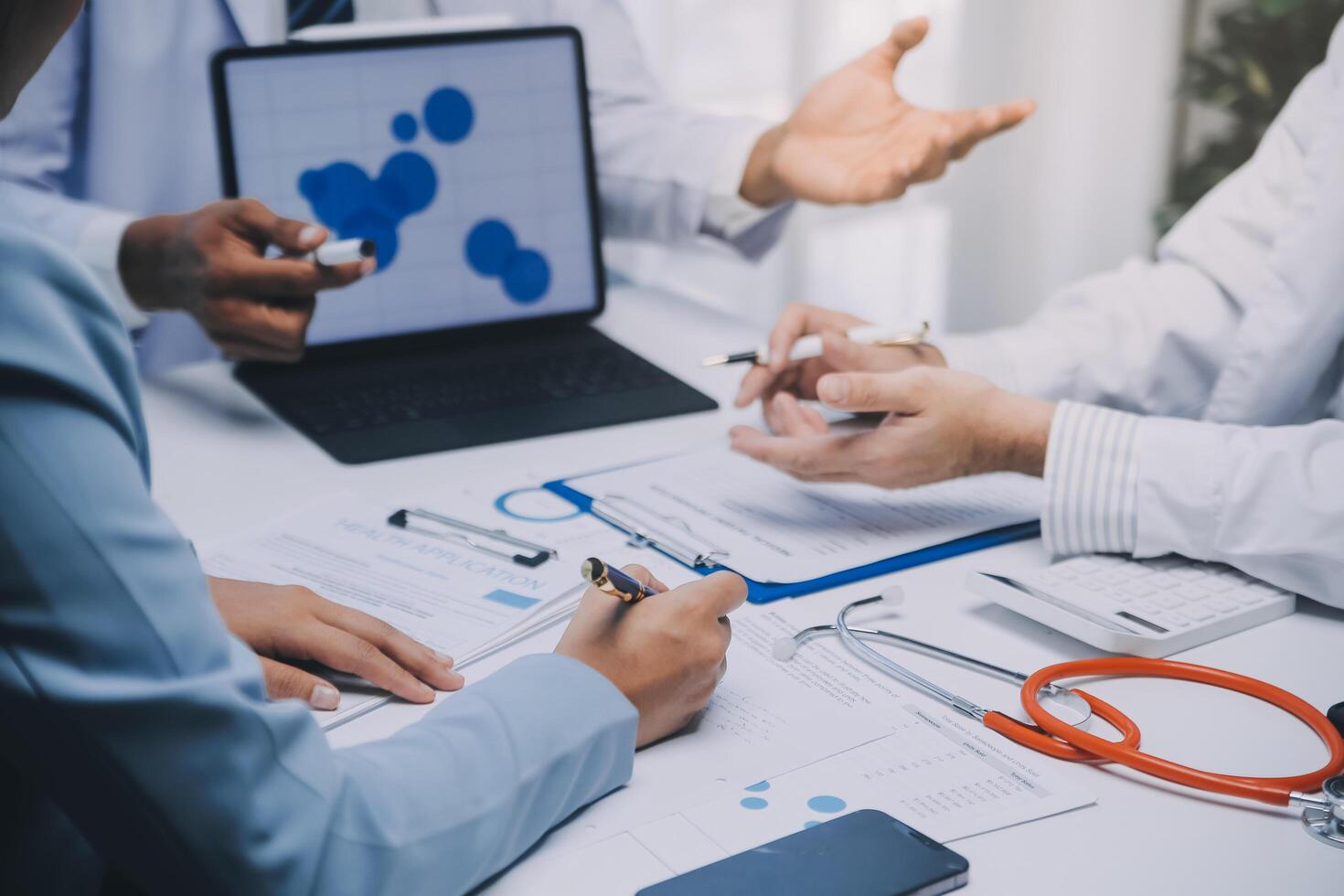 Meeting, tablet and team of doctors with collaboration for healthcare talk and telehealth app in office. Surgeon group, tech and medical discussion with website for hospital funding or sponsorship photo