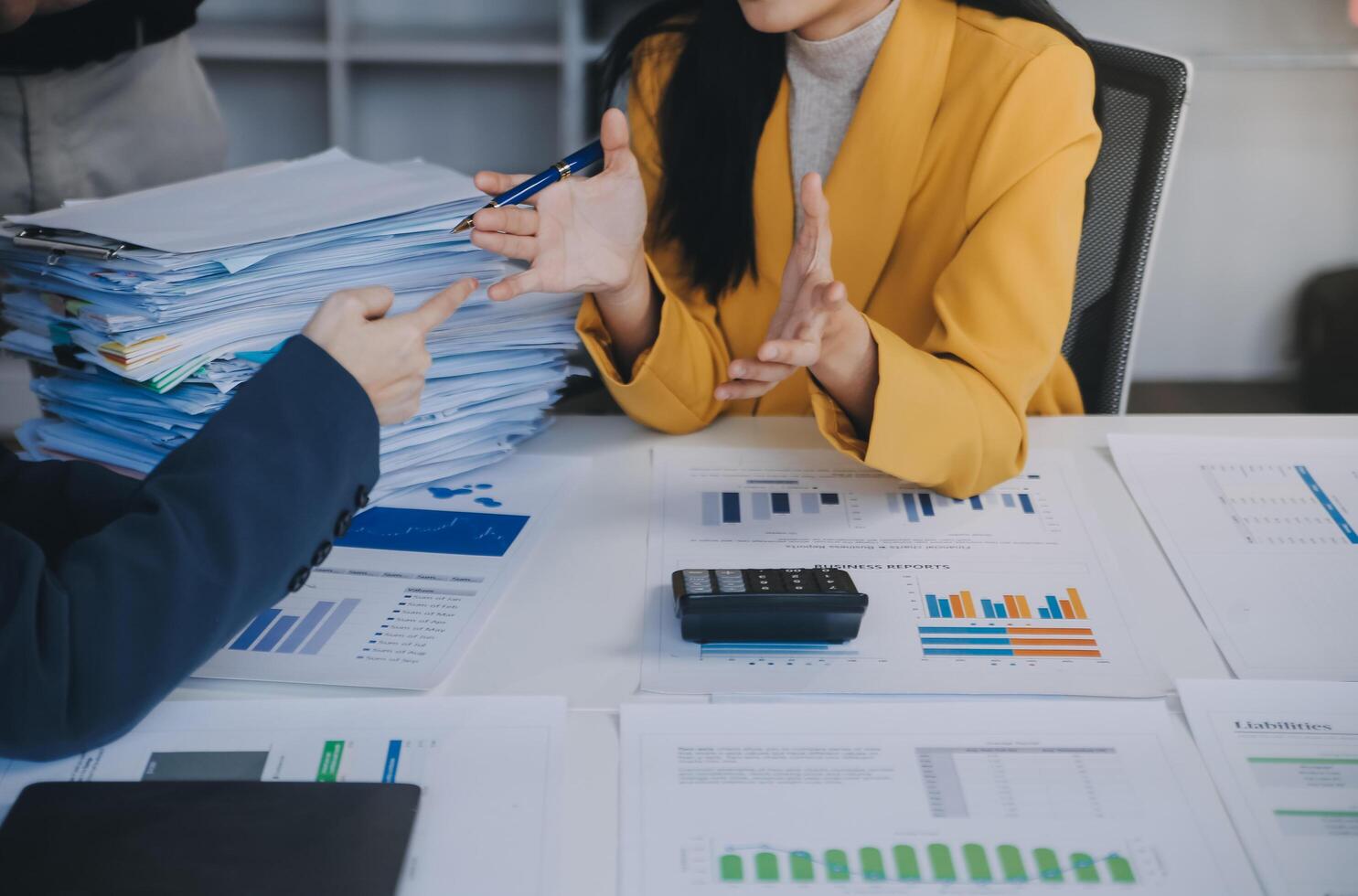Financial analysts analyze business financial reports on a digital tablet planning investment project during a discussion at a meeting of corporate showing the results of their successful teamwork. photo