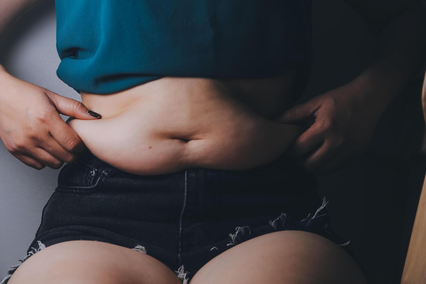 fat woman, fat belly, chubby, obese woman hand holding excessive belly fat with measure tape, woman diet lifestyle concept photo