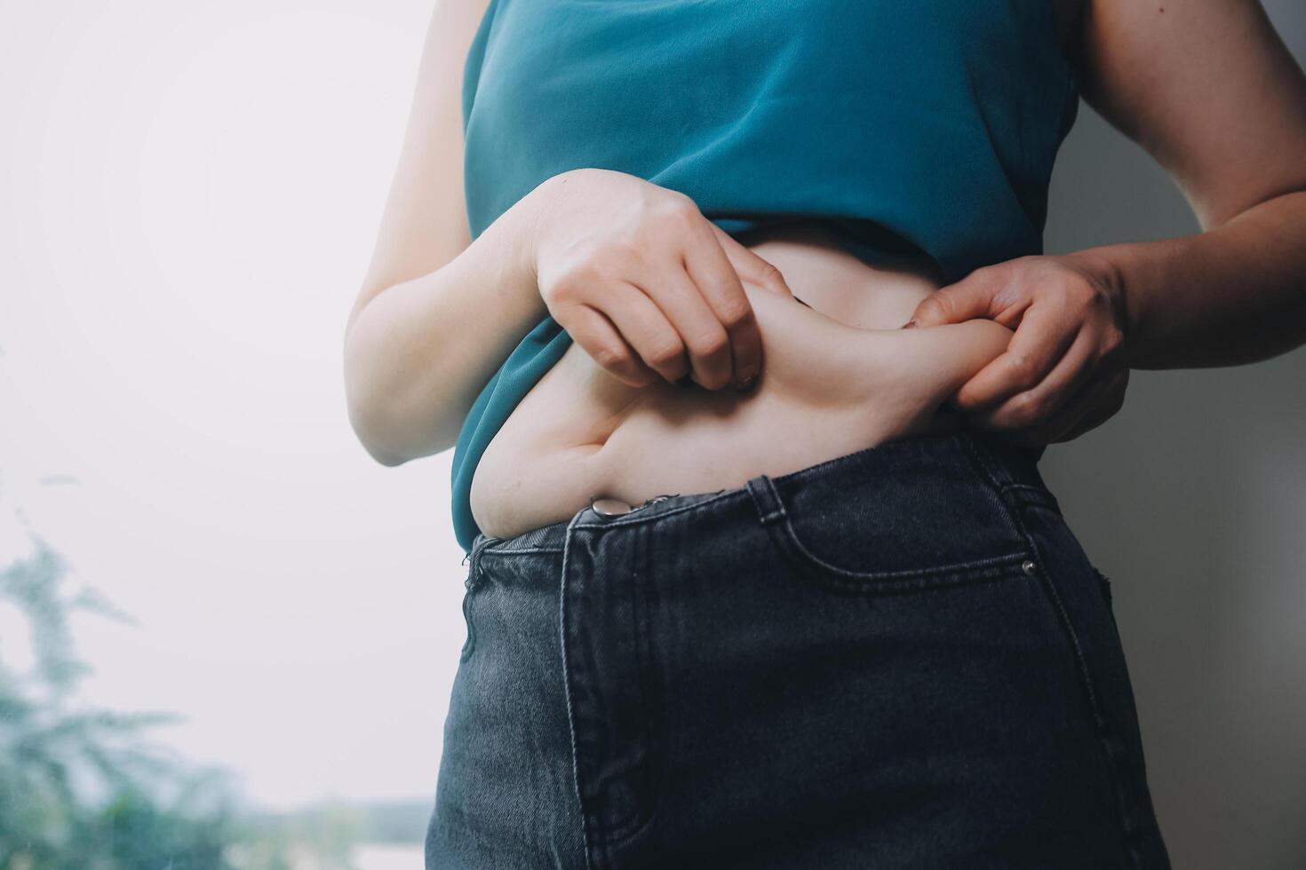 fat woman, fat belly, chubby, obese woman hand holding excessive belly fat with measure tape, woman diet lifestyle concept photo