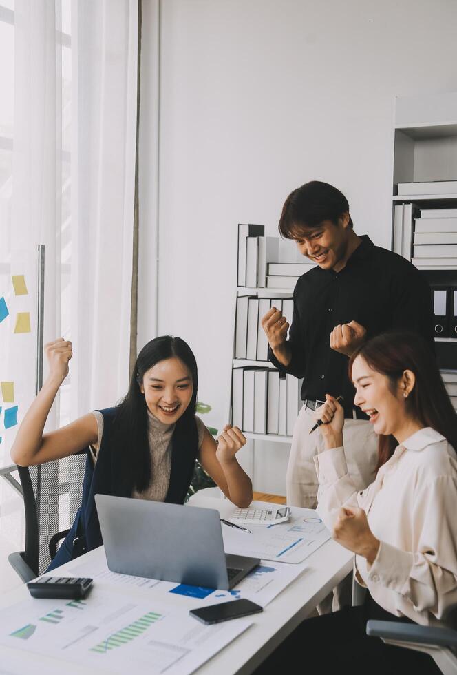 Financial analysts analyze business financial reports on a digital tablet planning investment project during a discussion at a meeting of corporate showing the results of their successful teamwork. photo