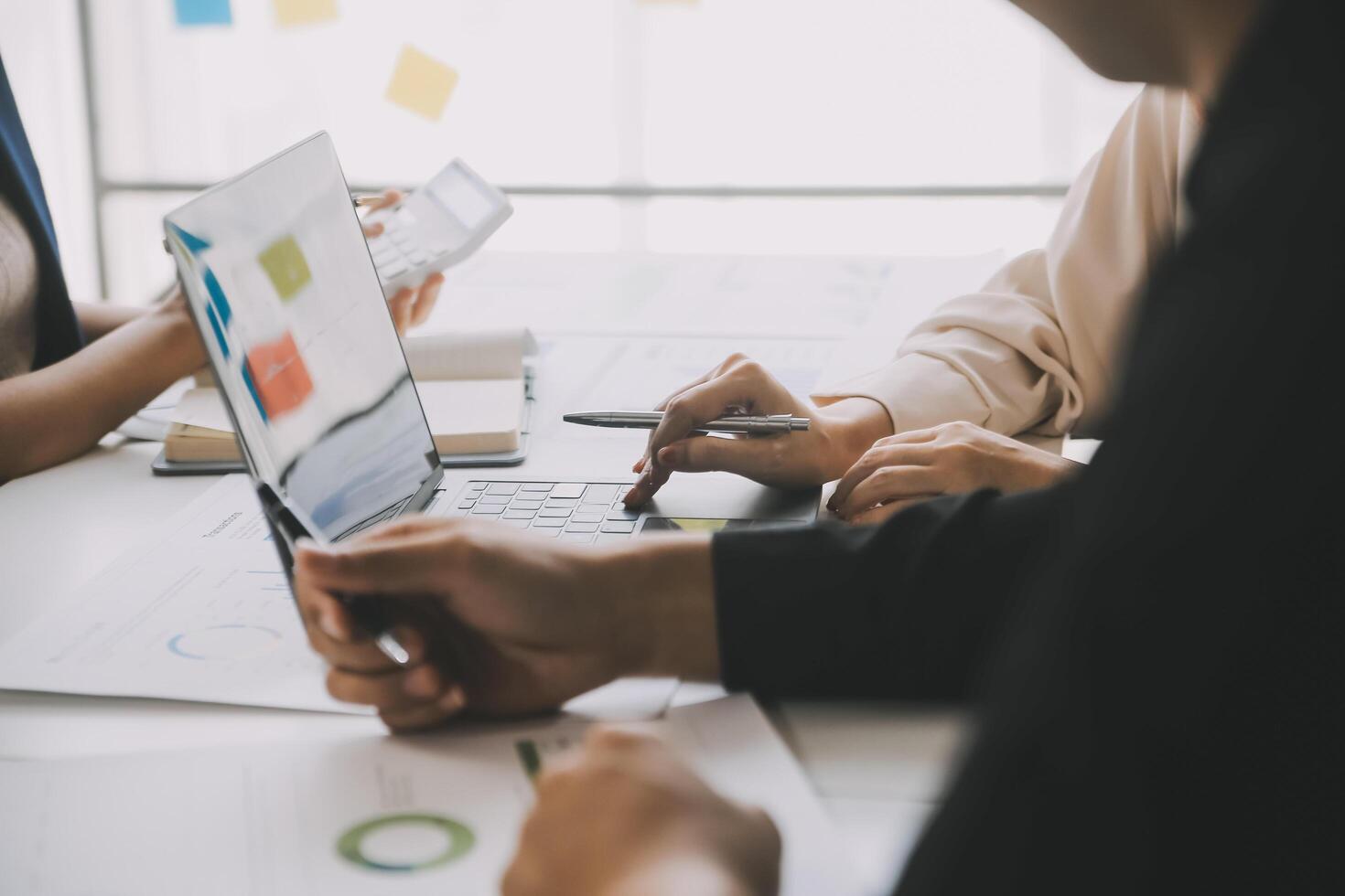 Financial analysts analyze business financial reports on a digital tablet planning investment project during a discussion at a meeting of corporate showing the results of their successful teamwork. photo