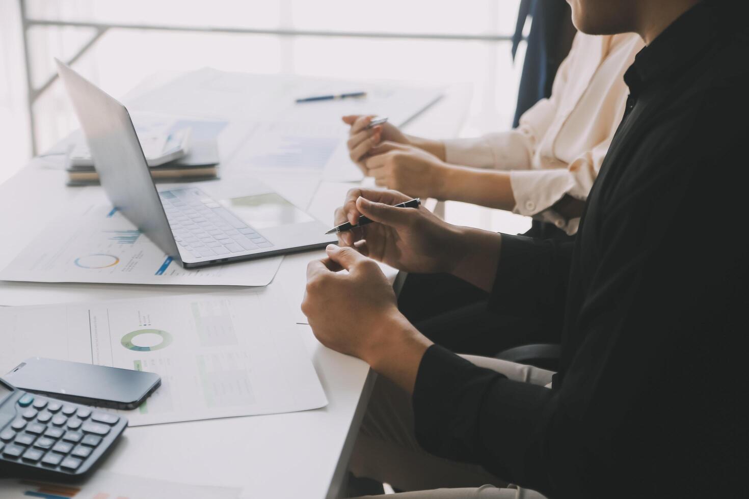 Financial analysts analyze business financial reports on a digital tablet planning investment project during a discussion at a meeting of corporate showing the results of their successful teamwork. photo