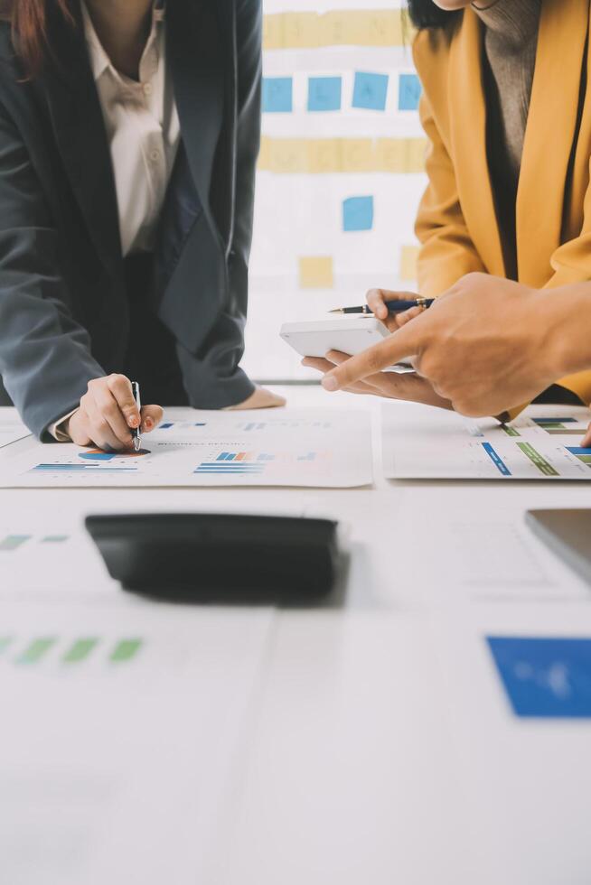 Financial analysts analyze business financial reports on a digital tablet planning investment project during a discussion at a meeting of corporate showing the results of their successful teamwork. photo