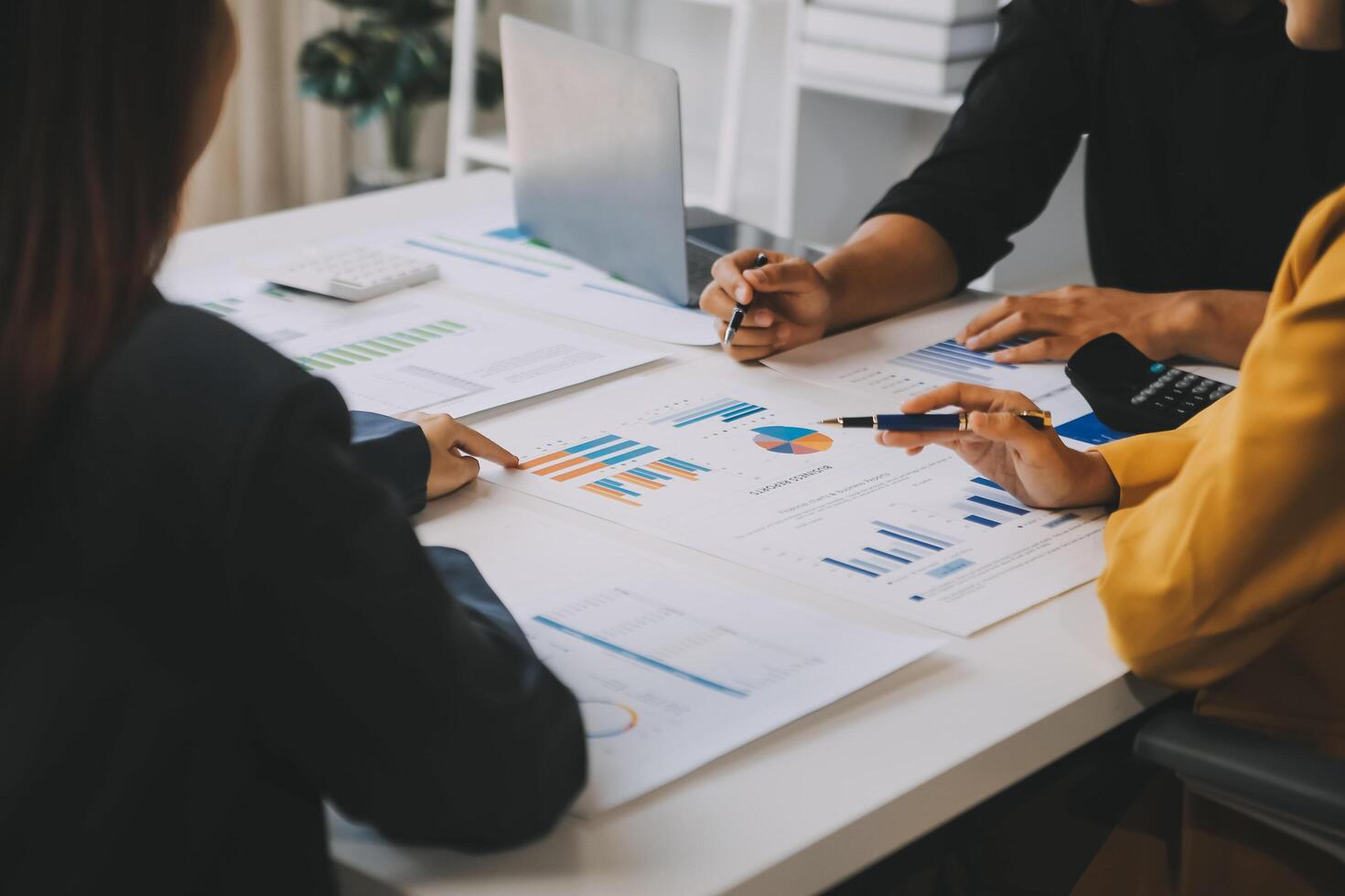 Financial analysts analyze business financial reports on a digital tablet planning investment project during a discussion at a meeting of corporate showing the results of their successful teamwork. photo