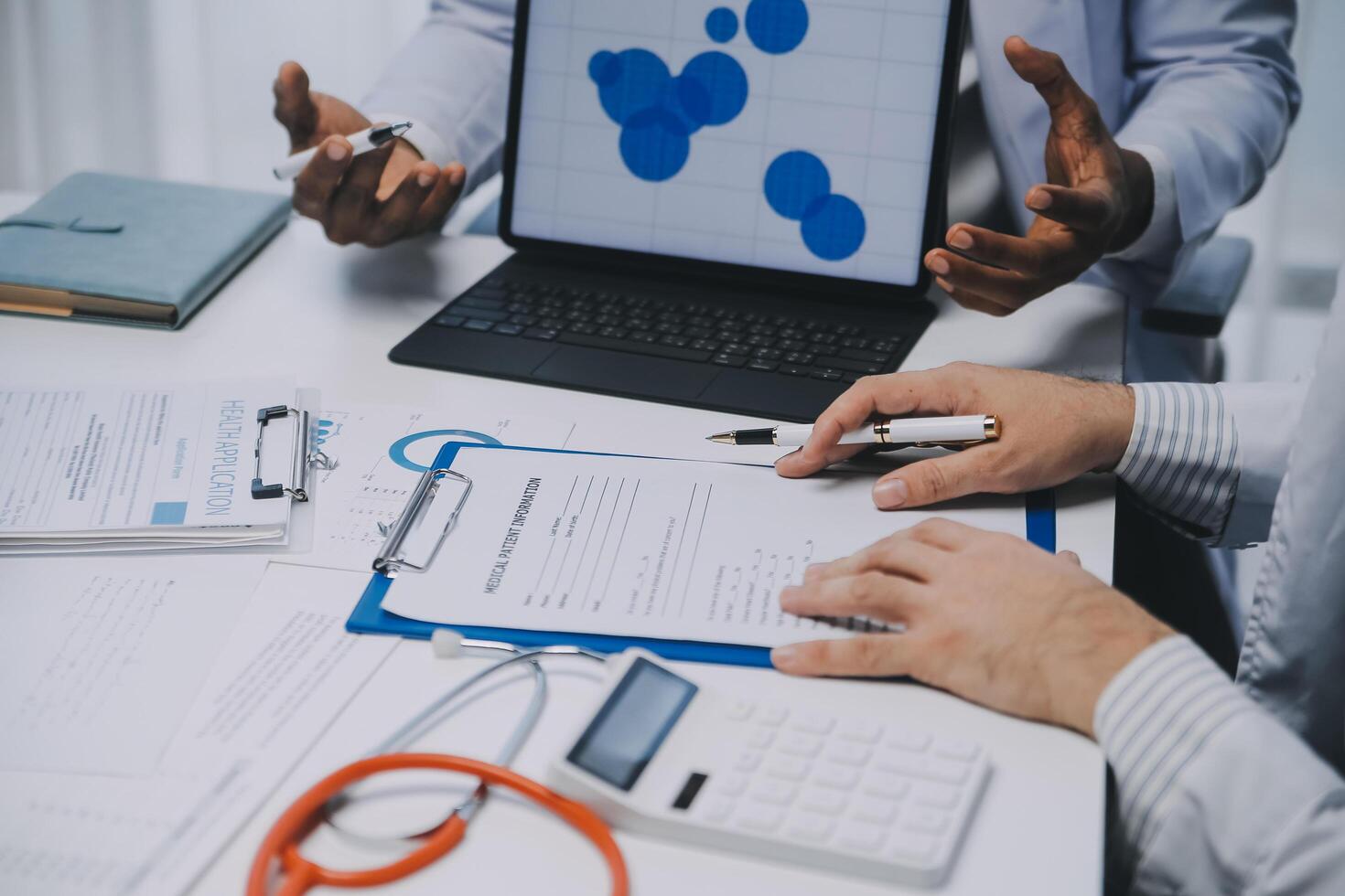 Meeting, tablet and team of doctors with collaboration for healthcare talk and telehealth app in office. Surgeon group, tech and medical discussion with website for hospital funding or sponsorship photo