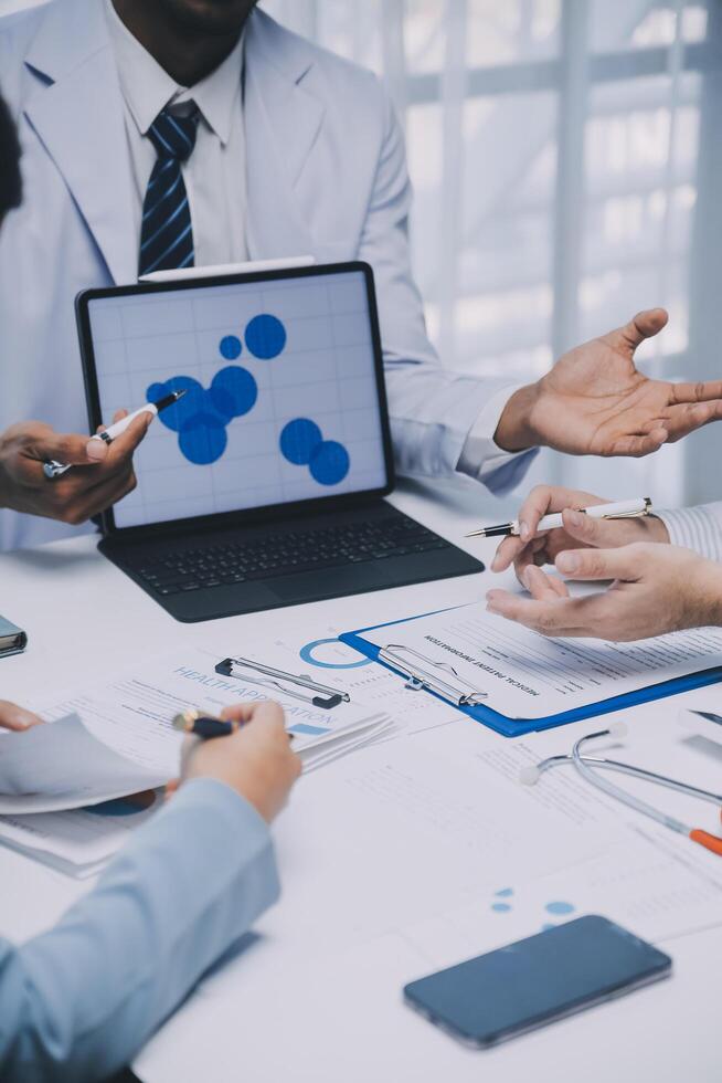 Meeting, tablet and team of doctors with collaboration for healthcare talk and telehealth app in office. Surgeon group, tech and medical discussion with website for hospital funding or sponsorship photo