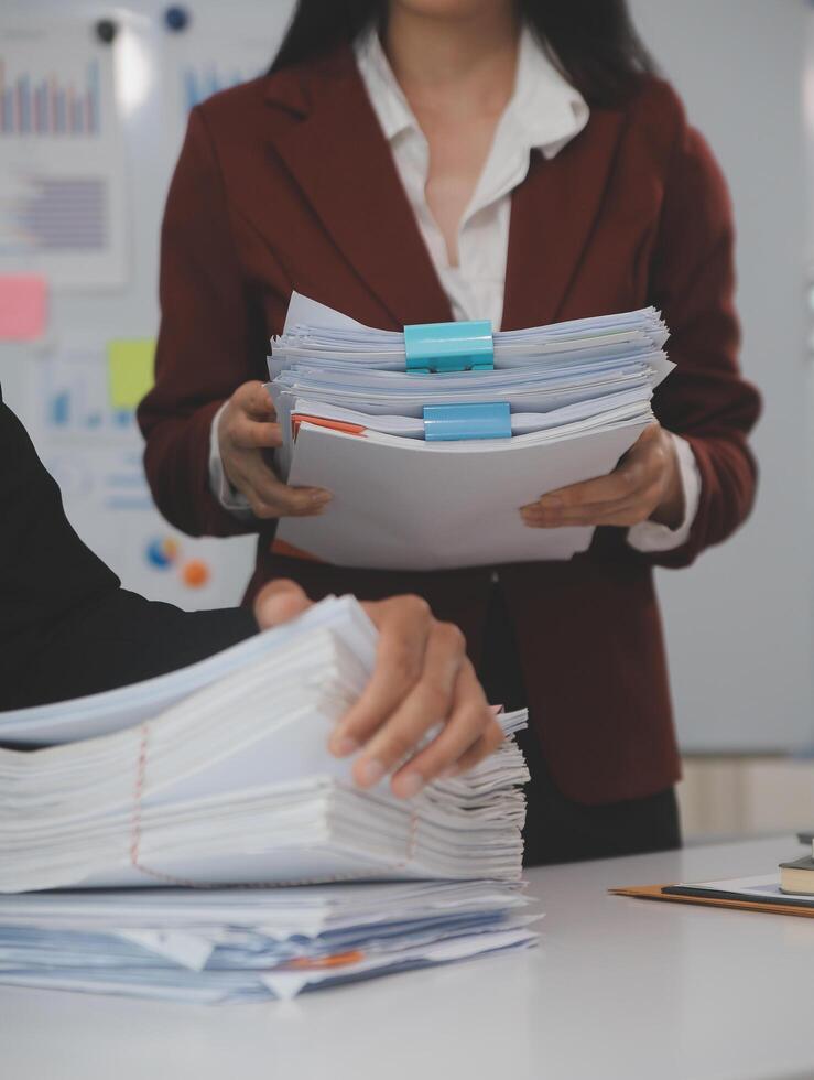 Audit concept,Administrator business man financial inspector and secretary making report calculating balance. Internal Revenue Service checking document. photo