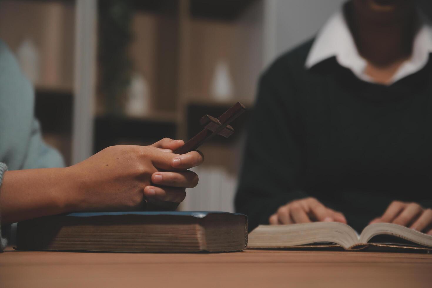 Christian group are praying to god with the bible and sharing the gospel. Concept of faith for god. photo