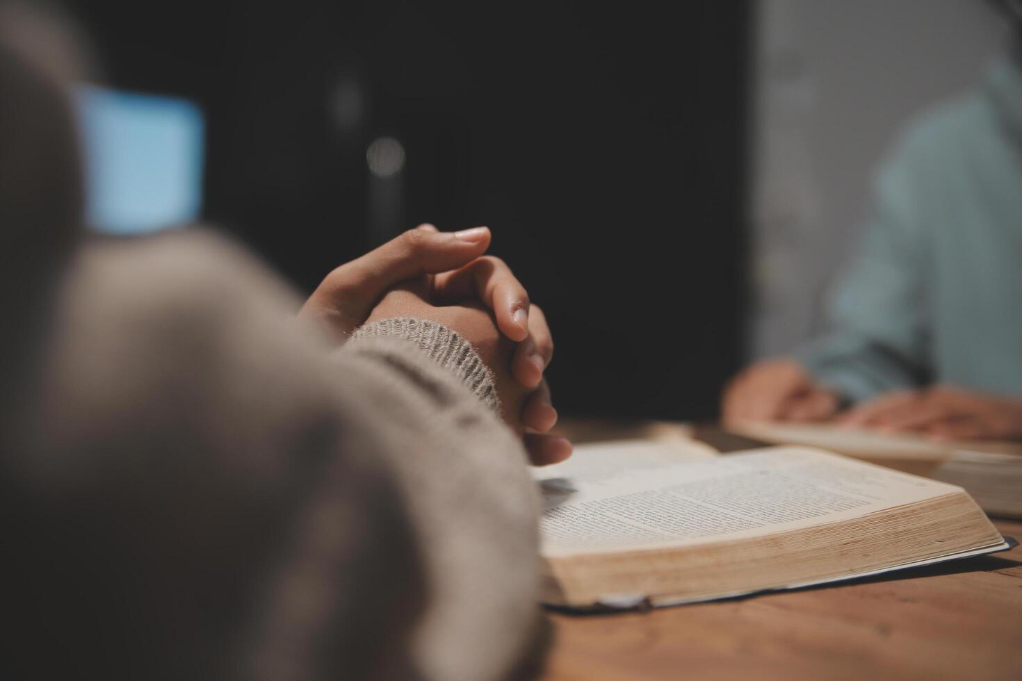 Christian group are praying to god with the bible and sharing the gospel. Concept of faith for god. photo