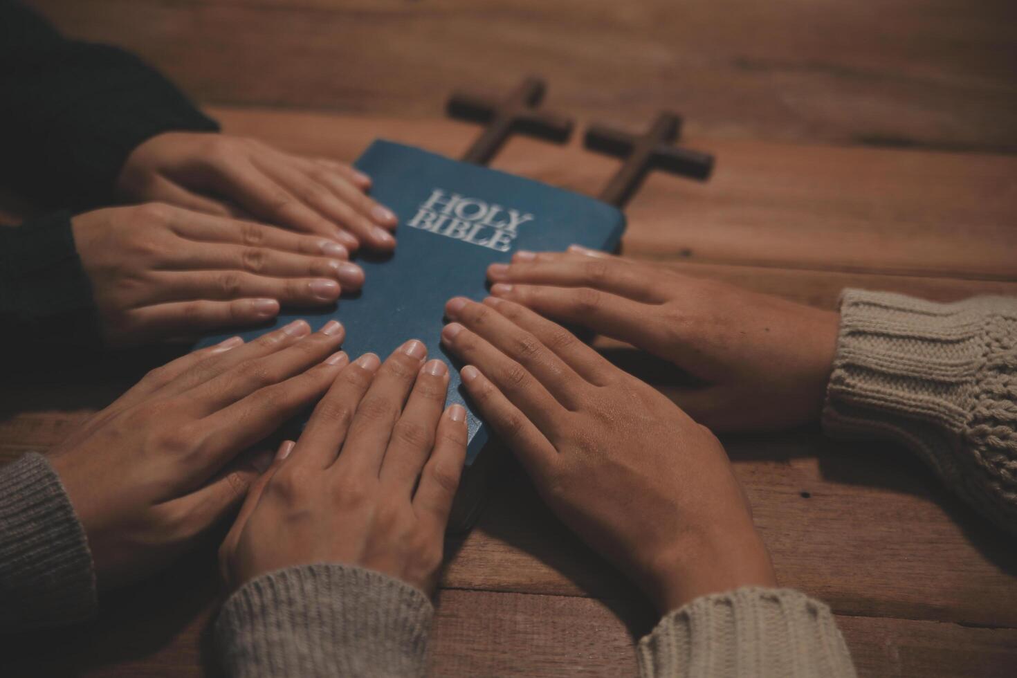 Christian group are praying to god with the bible and sharing the gospel. Concept of faith for god. photo