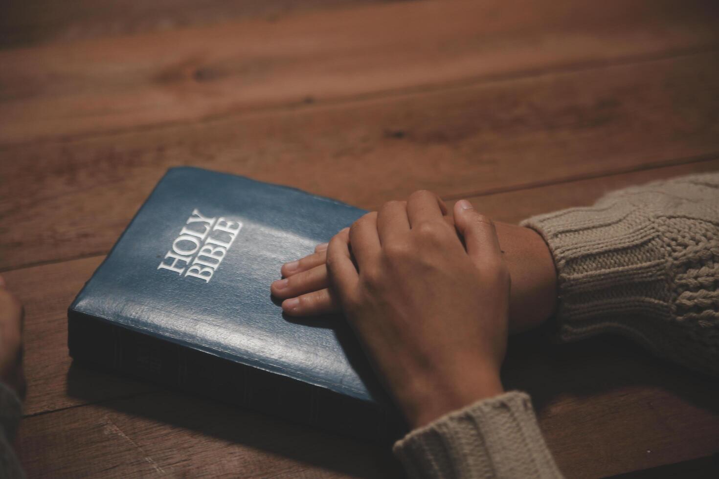Christian group are praying to god with the bible and sharing the gospel. Concept of faith for god. photo