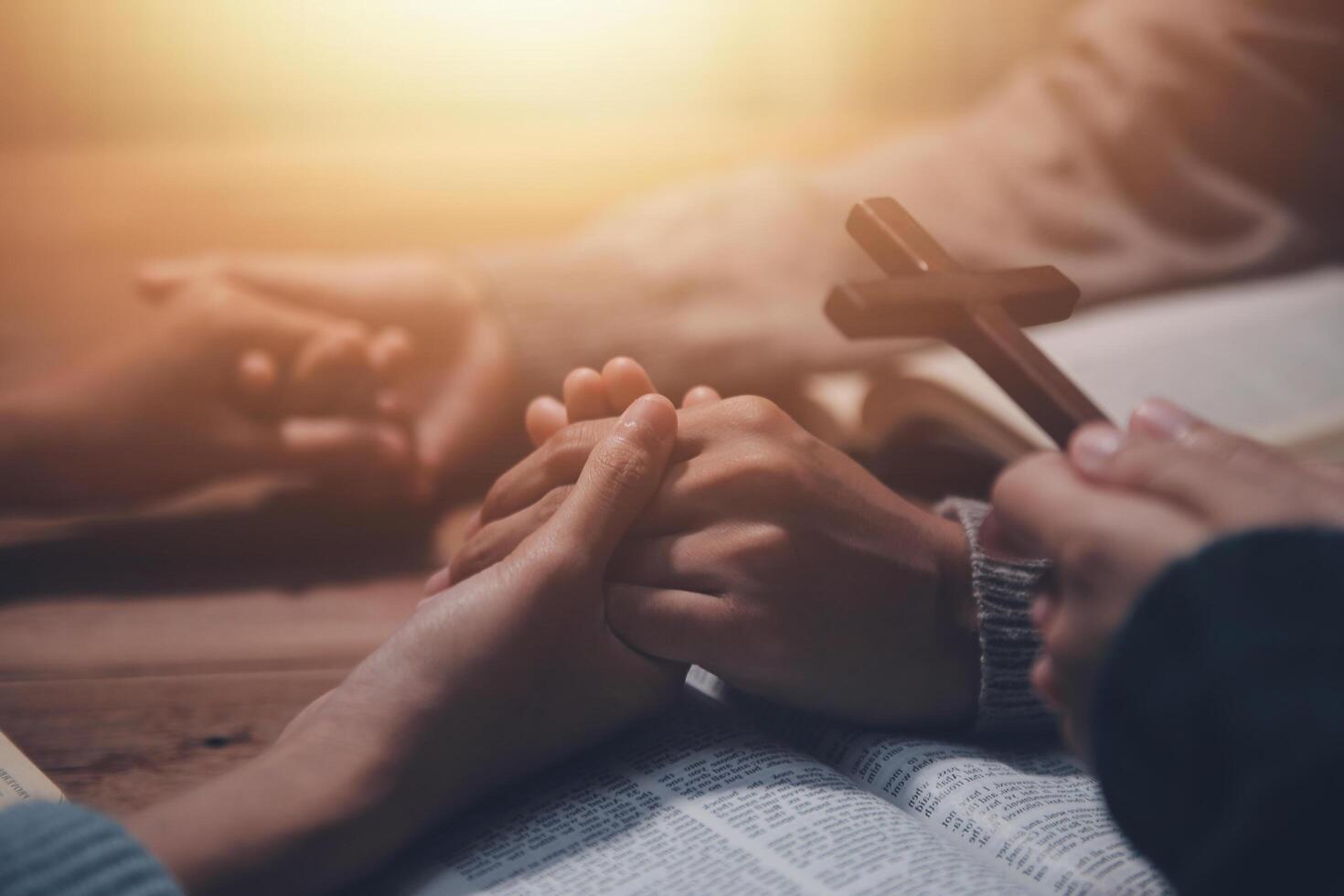 Christian group are praying to god with the bible and sharing the gospel. Concept of faith for god. photo