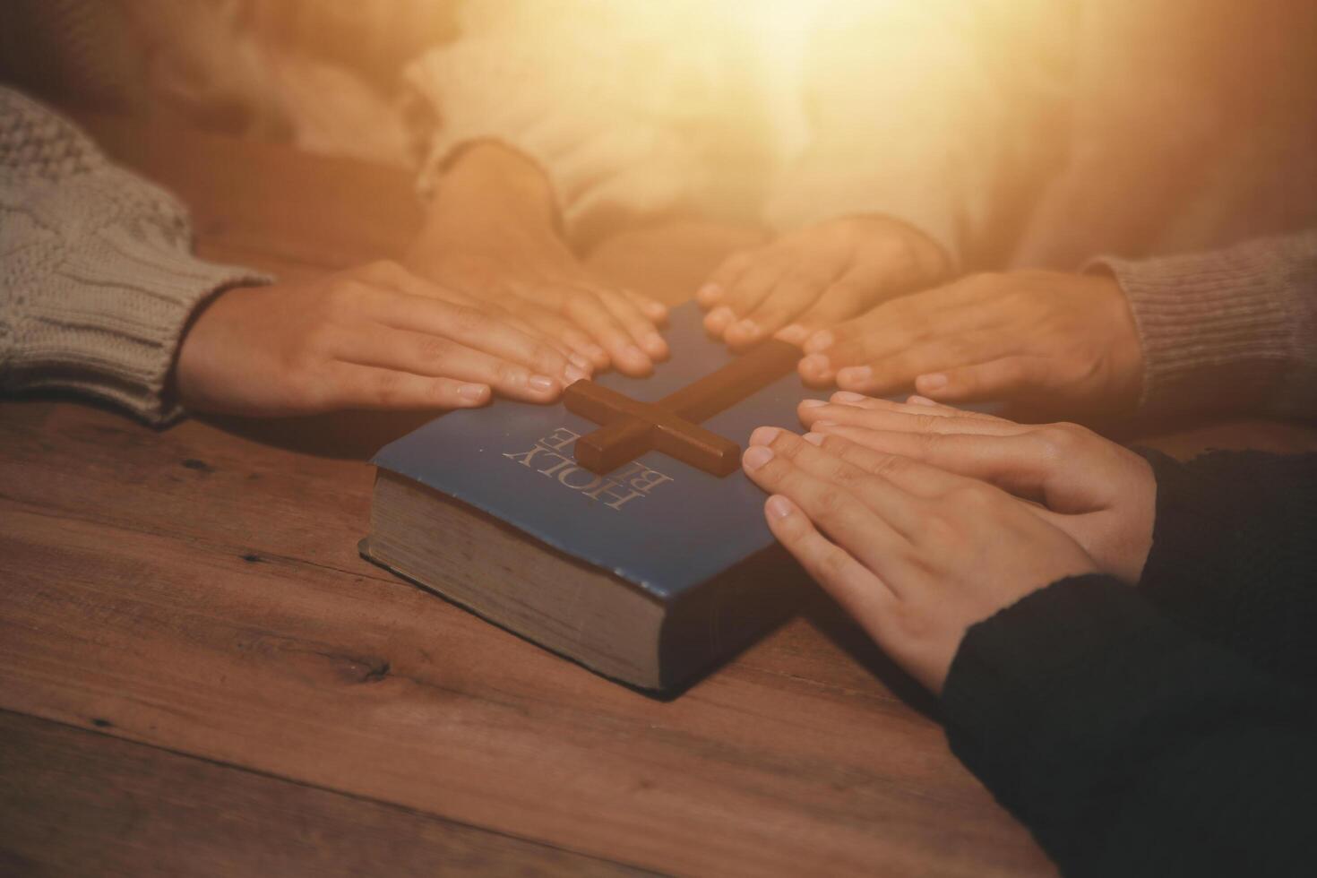 Christian group are praying to god with the bible and sharing the gospel. Concept of faith for god. photo