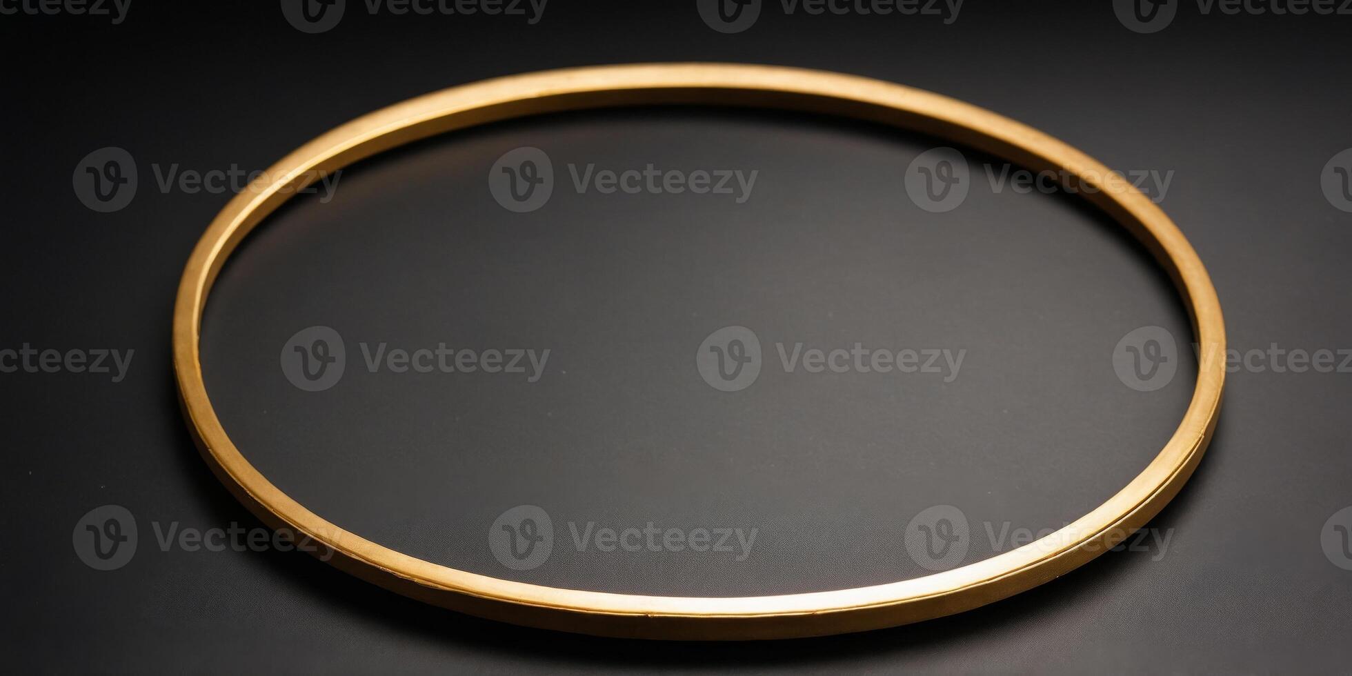 A single golden circular frame sits on a black background. photo