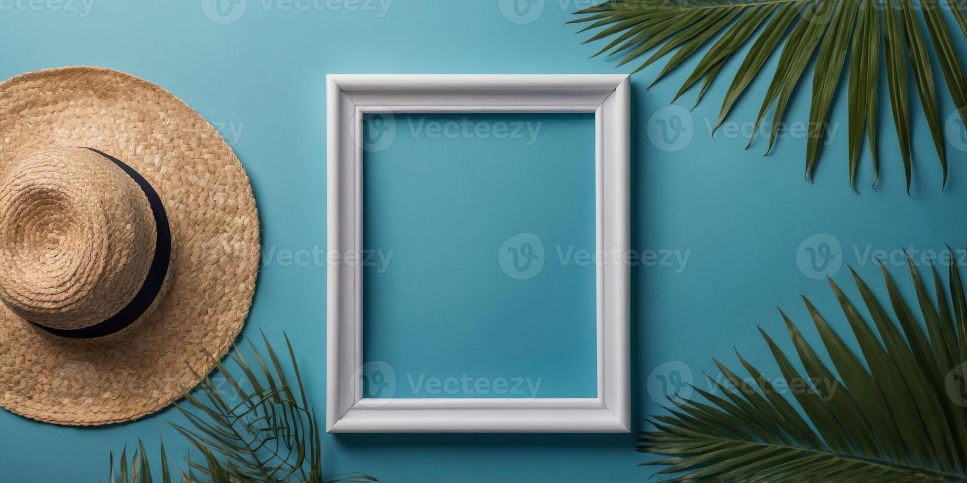 Summer flat lay with empty white picture frame surrounded by tropical palm leaves and straw hat on blue background. photo