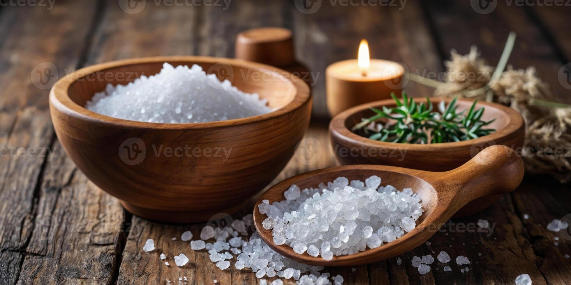 Coarse sea salt in wooden bowls over rustic wooden table. photo