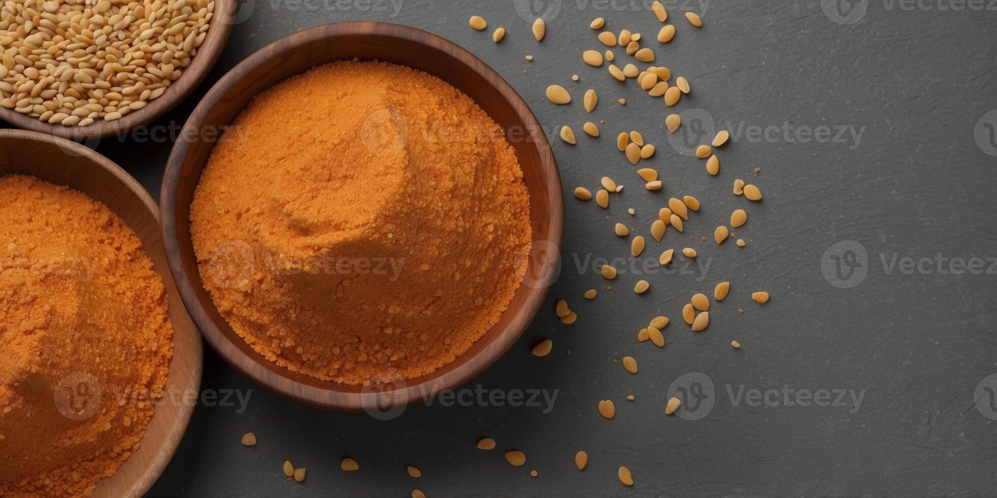 red lentil flour in wooden bowl on gray background top view. photo