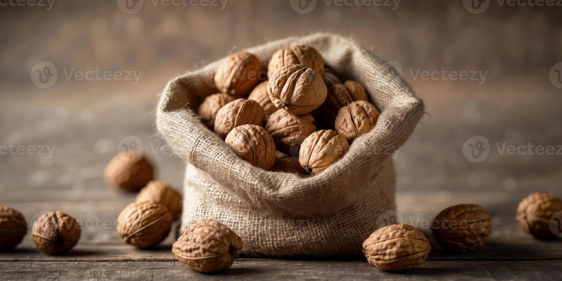 Rustic walnuts in burlap sack on wooden surface. photo