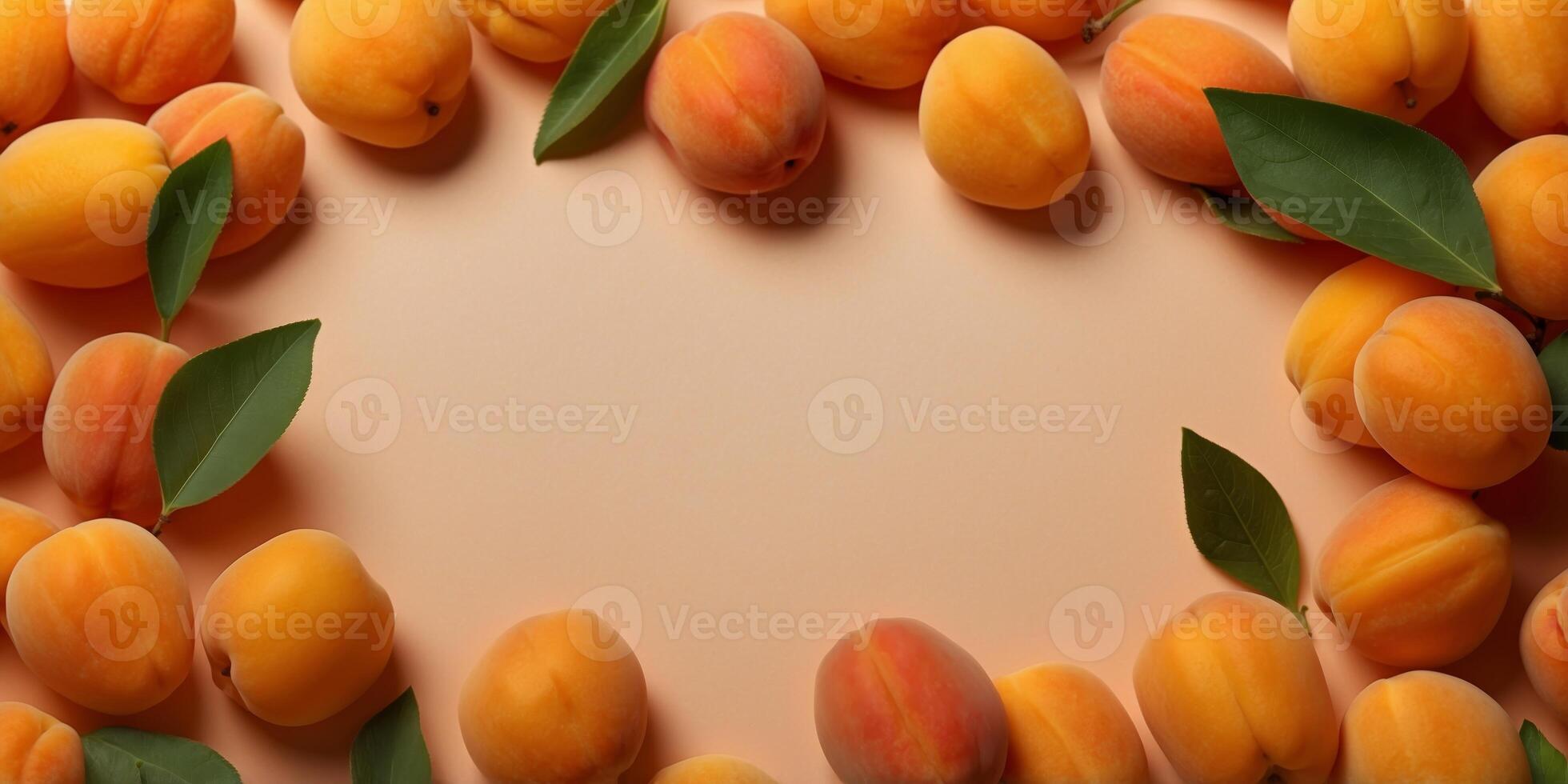 frame made of delicious apricots with leaves on orange background with copy space in the middle. photo