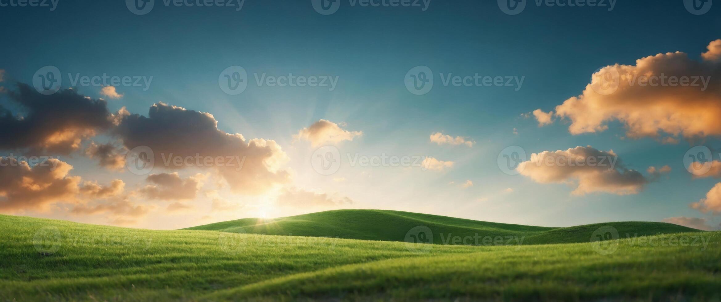 Small clouds over horizon over green grass hill. photo