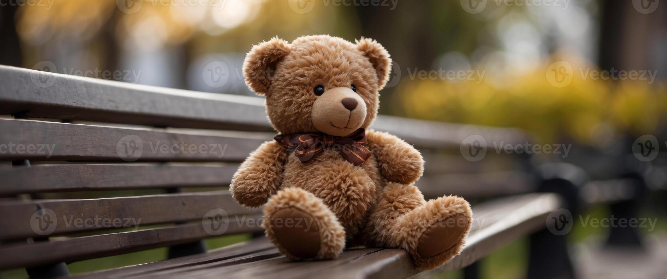 brown color small teddy bear on park bench. photo
