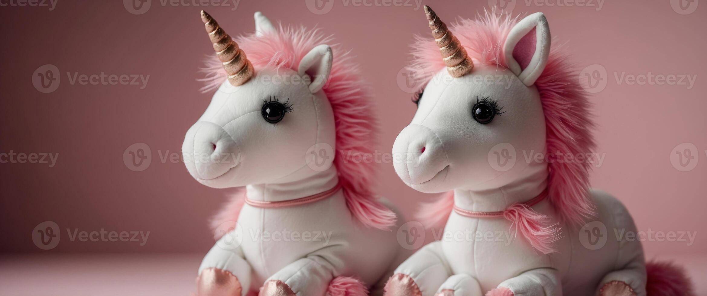 Cute soft unicorn plush toy on pink background. photo
