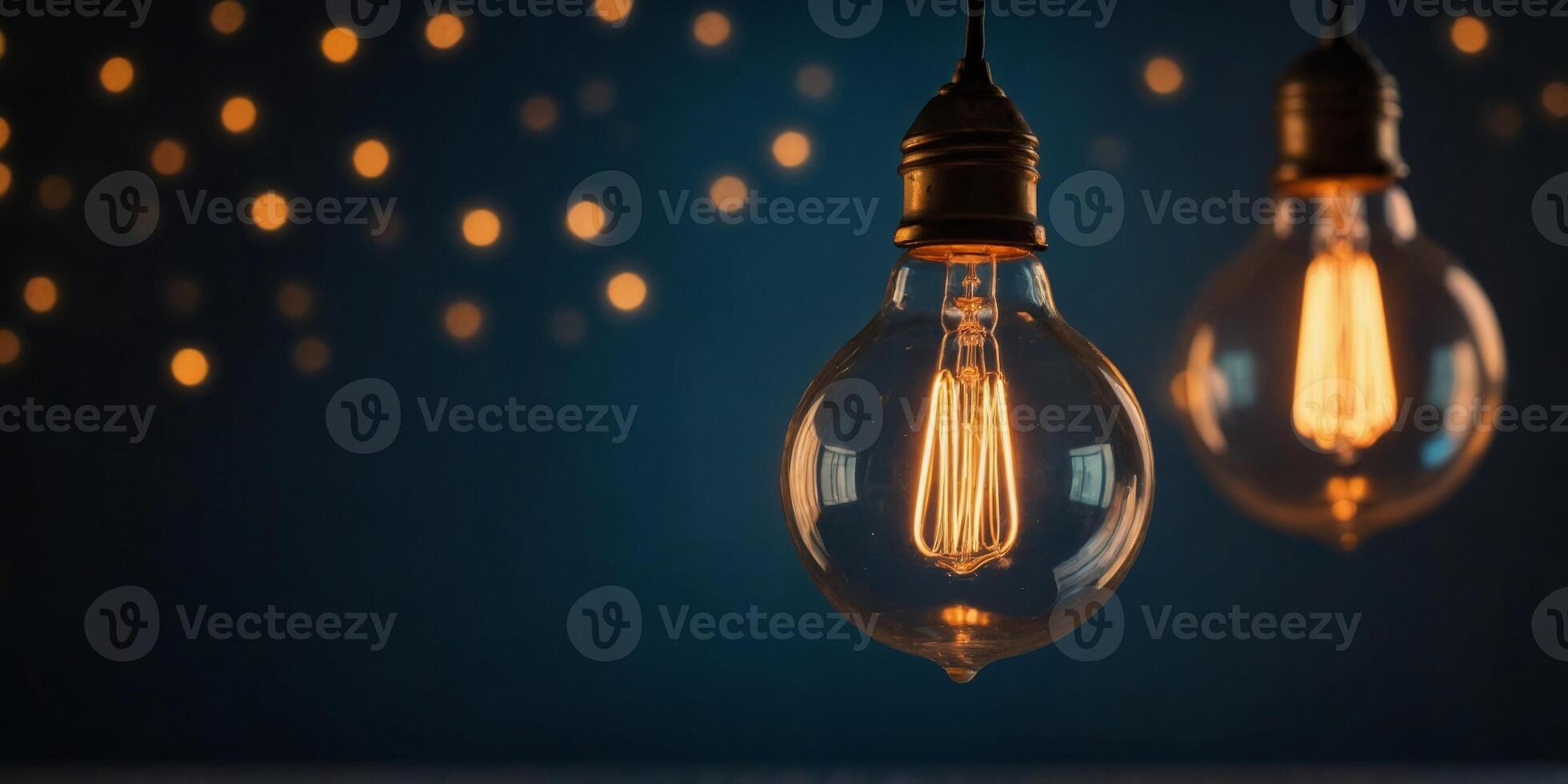 A light bulb is lit up and hanging from a string. photo