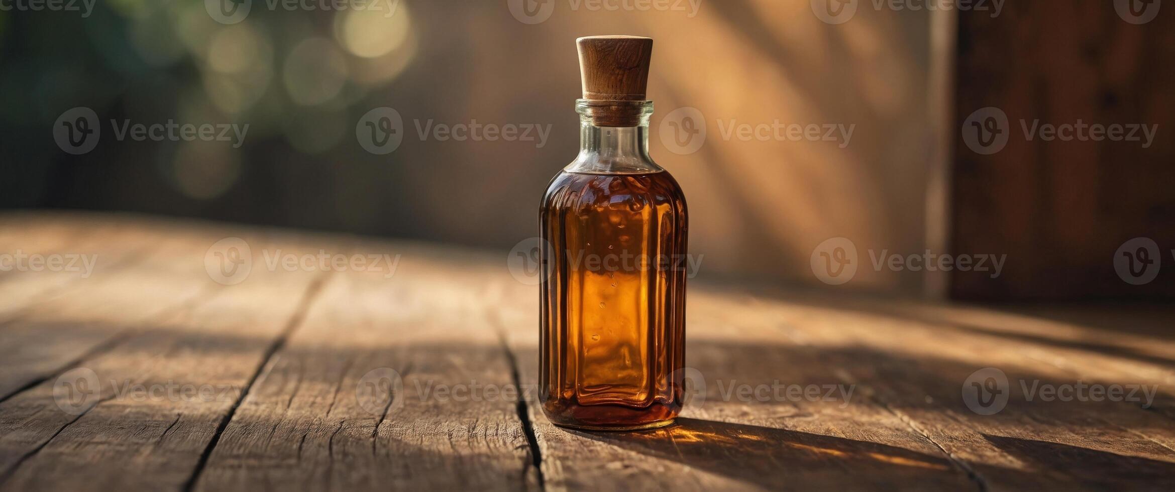 Amber glass bottle on wooden surface with floral shadows. photo