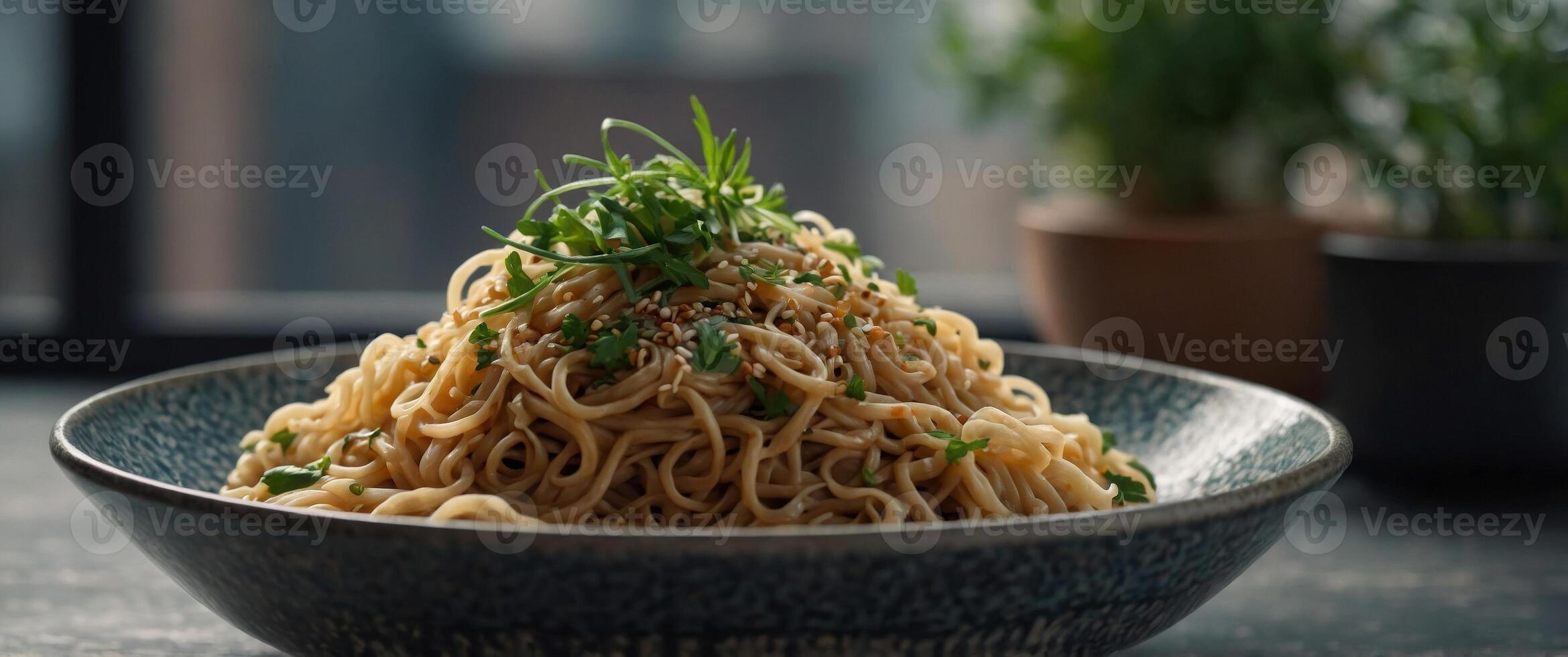 Noodles topped with fresh herbs and sesame seeds are served in a bowl. photo