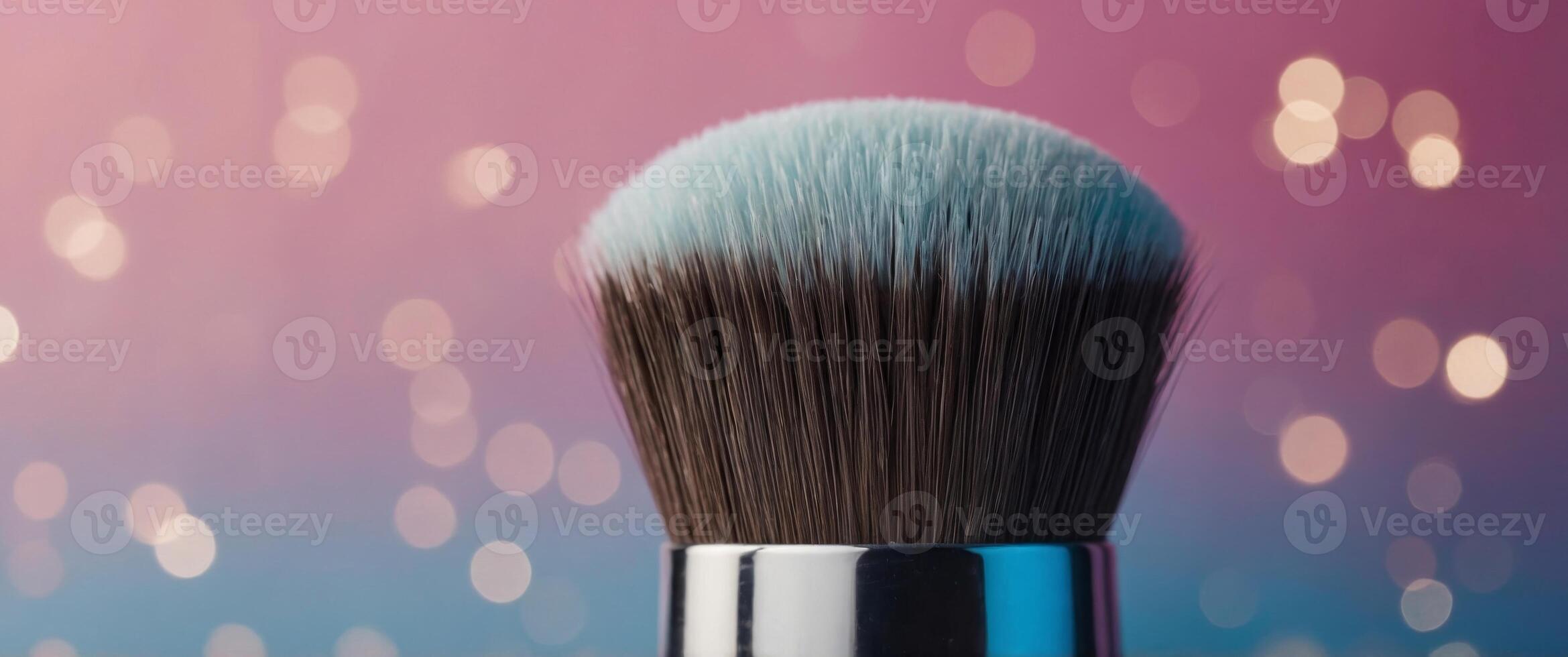 Close up of a makeup brush on pink and blue background. photo