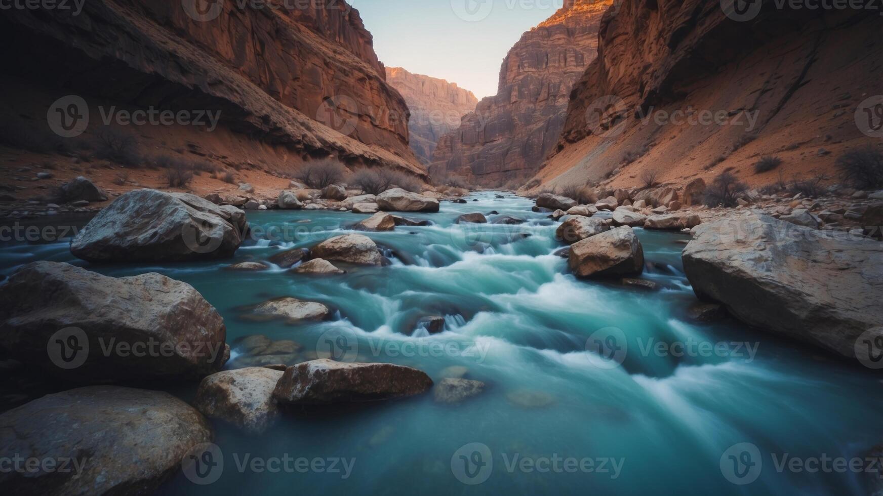 An river with a blue color is flowing through a canyon. photo