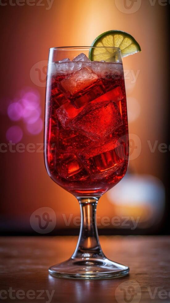 An glass of colorful drink with a red background. photo