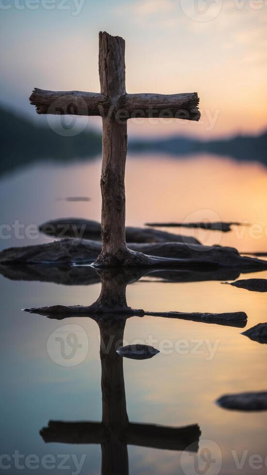 Driftwood Cross Reflecting in Tranquil Lake Symbolizing Peaceful Spirituality. photo