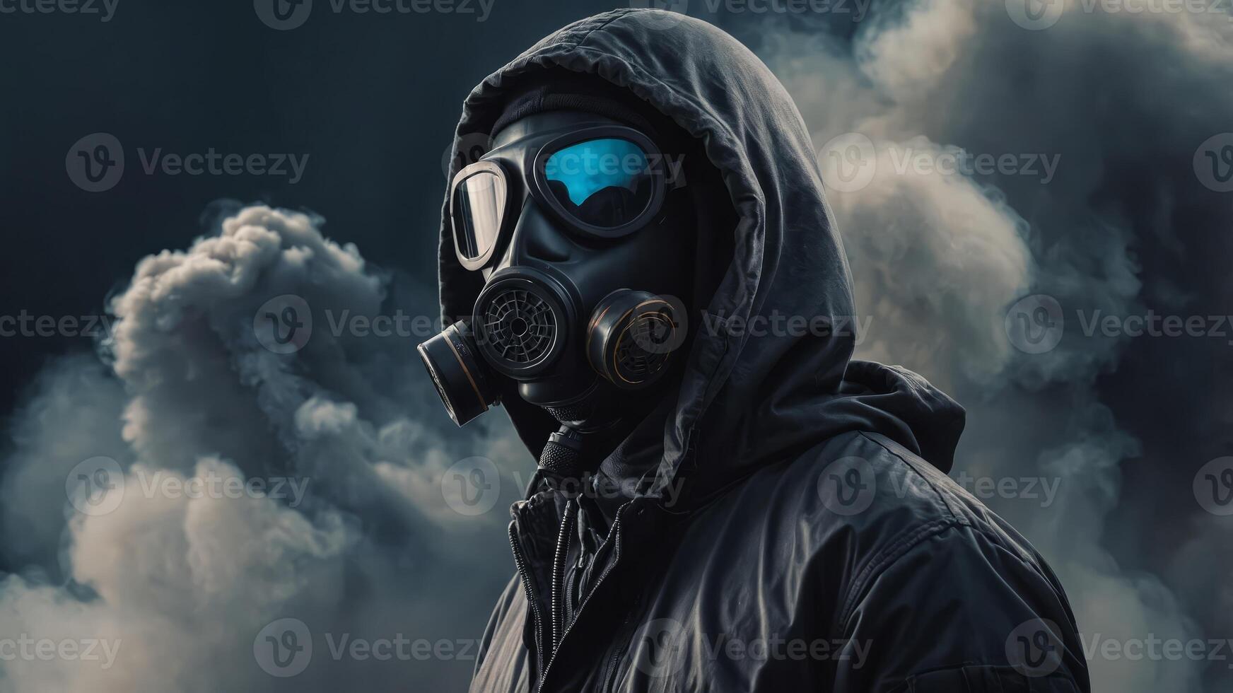a man in a hood and in a gas mask in clouds of smoke around. photo