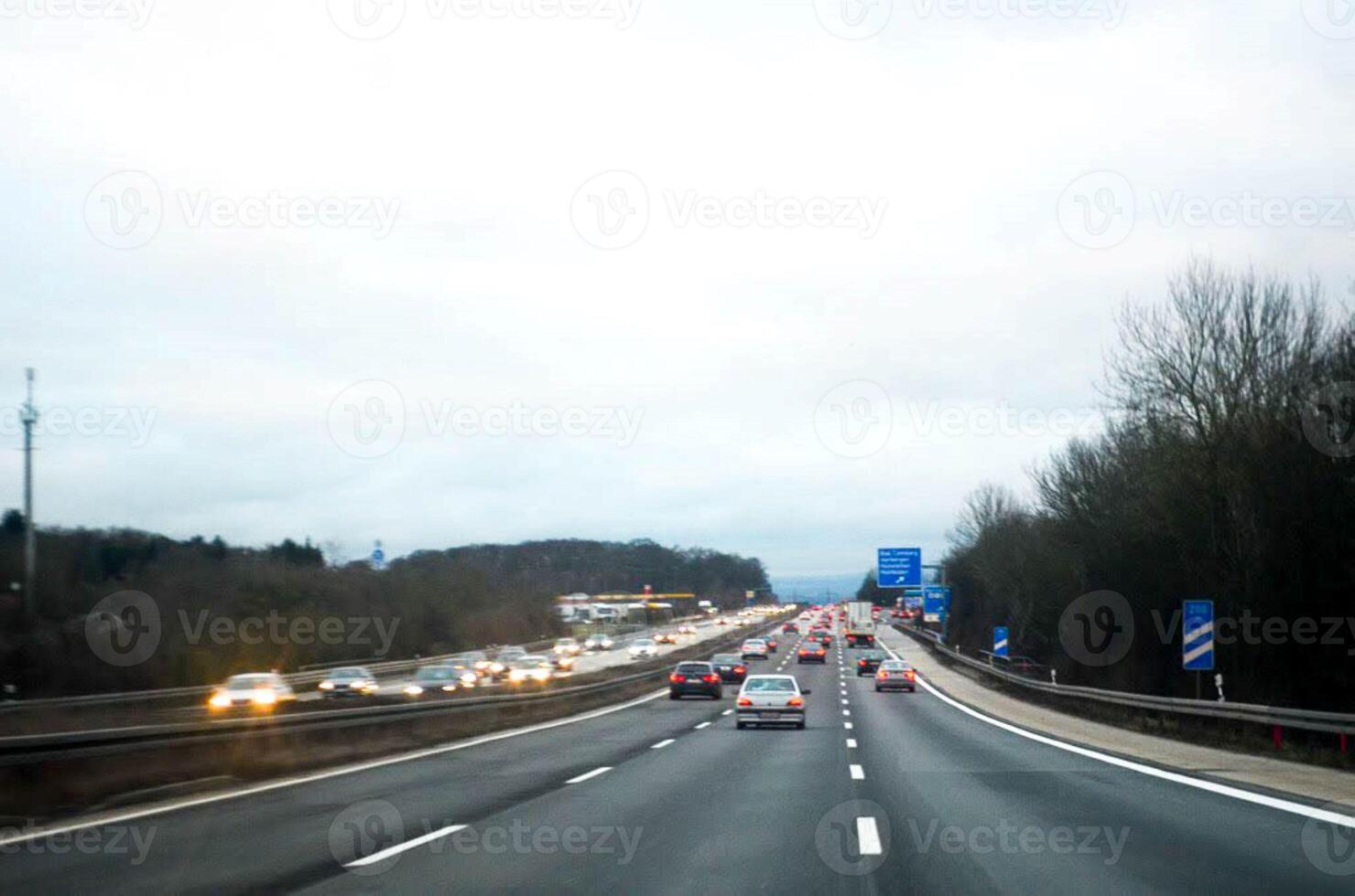 Traffic on highway in the cloudy day photo