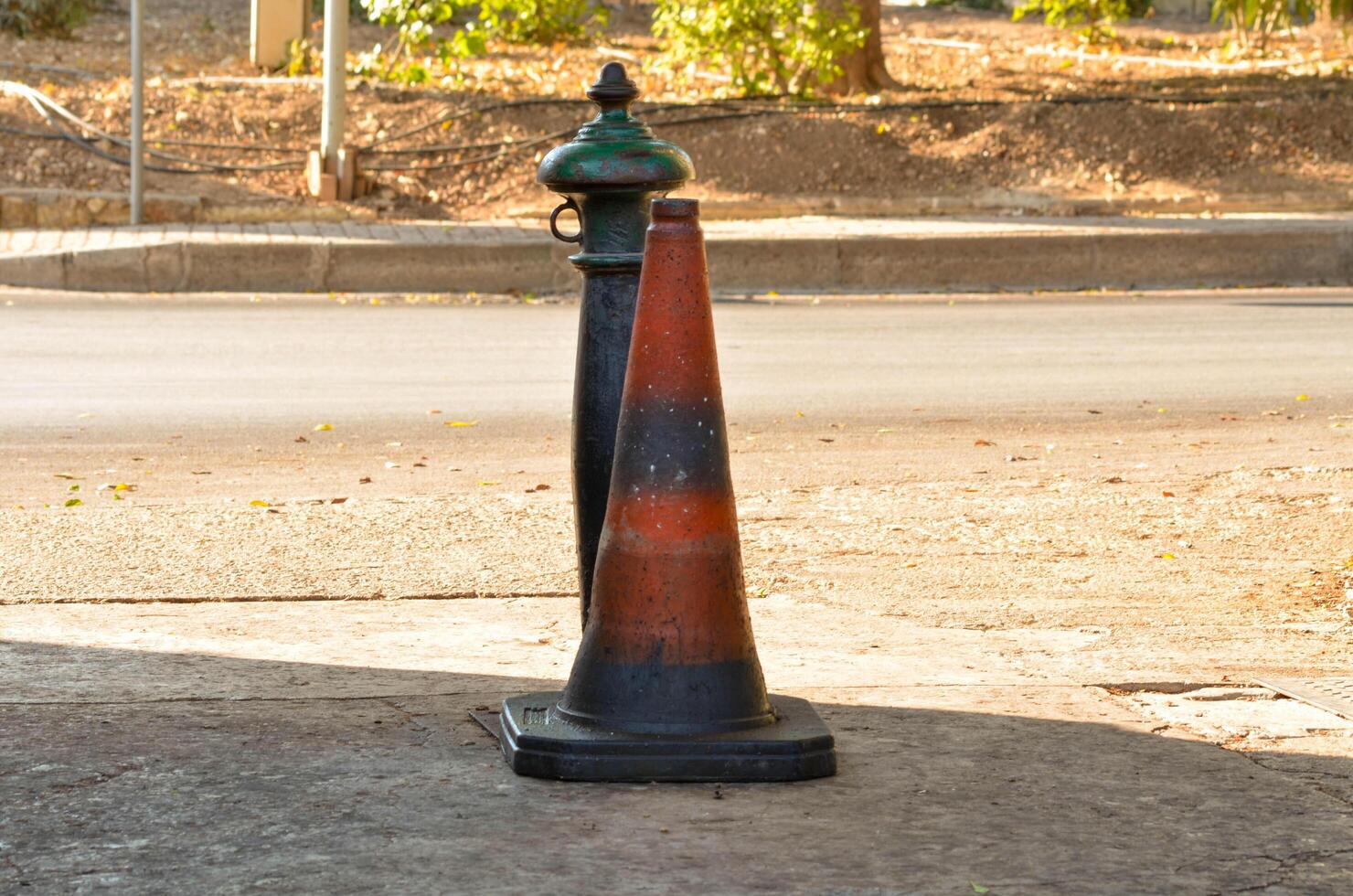 Urban Street Scene with Weathered Traffic Cone and Old Fire Hydrant photo
