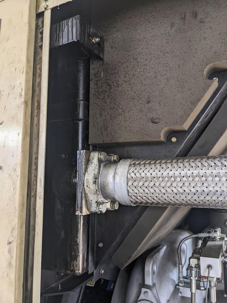 Close up of a Flexible Hose Connected for oil circulation air compressor photo