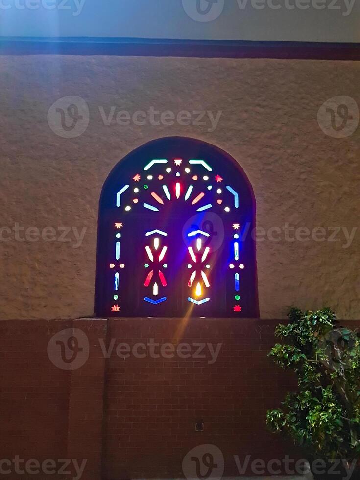 A wooden window creates different colors while turning on the light from inside photo