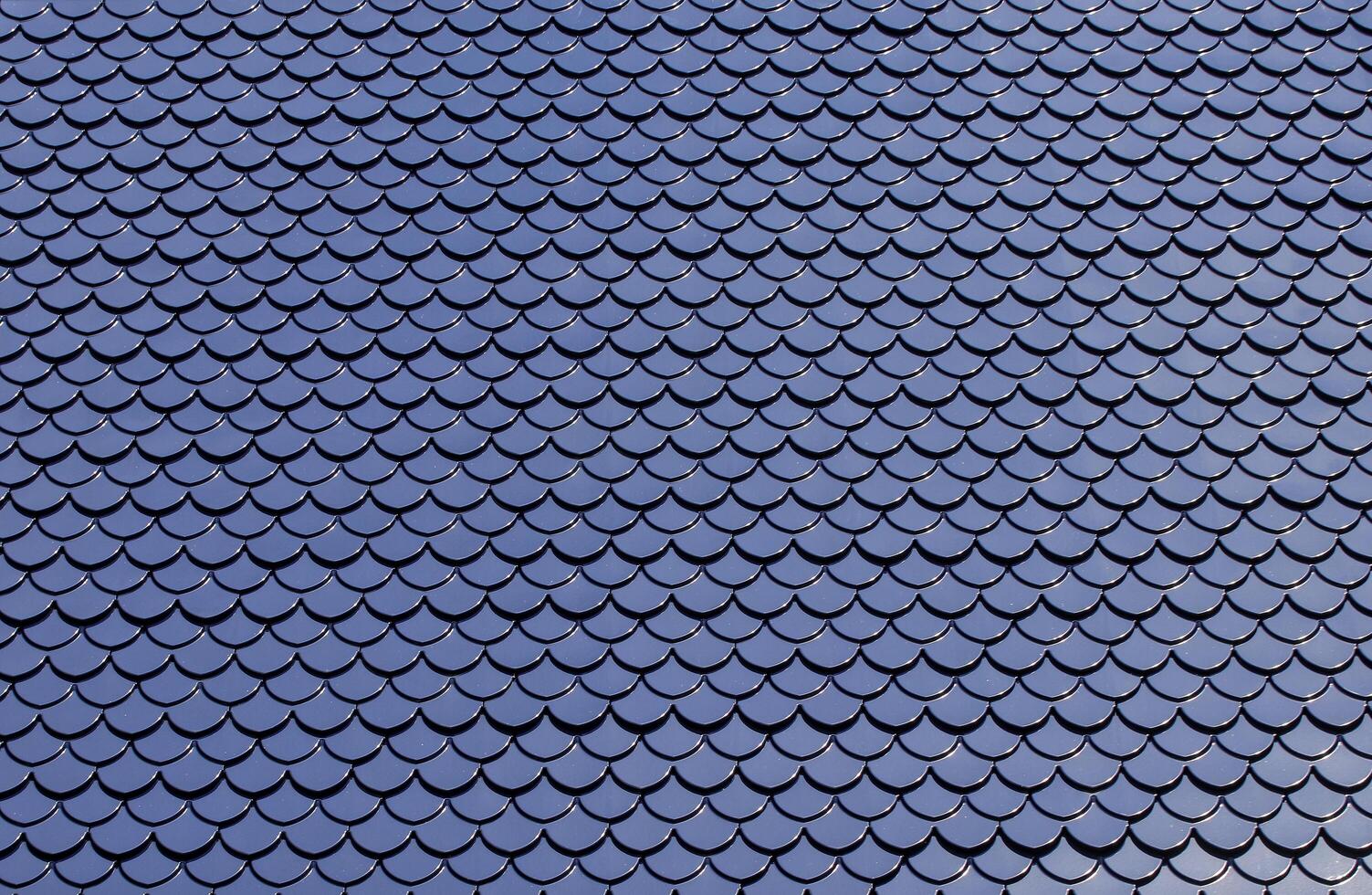 The roof tiles are similar to fish scales. Cement melting artist into the template, making the sheet continuously long throughout the roof. photo