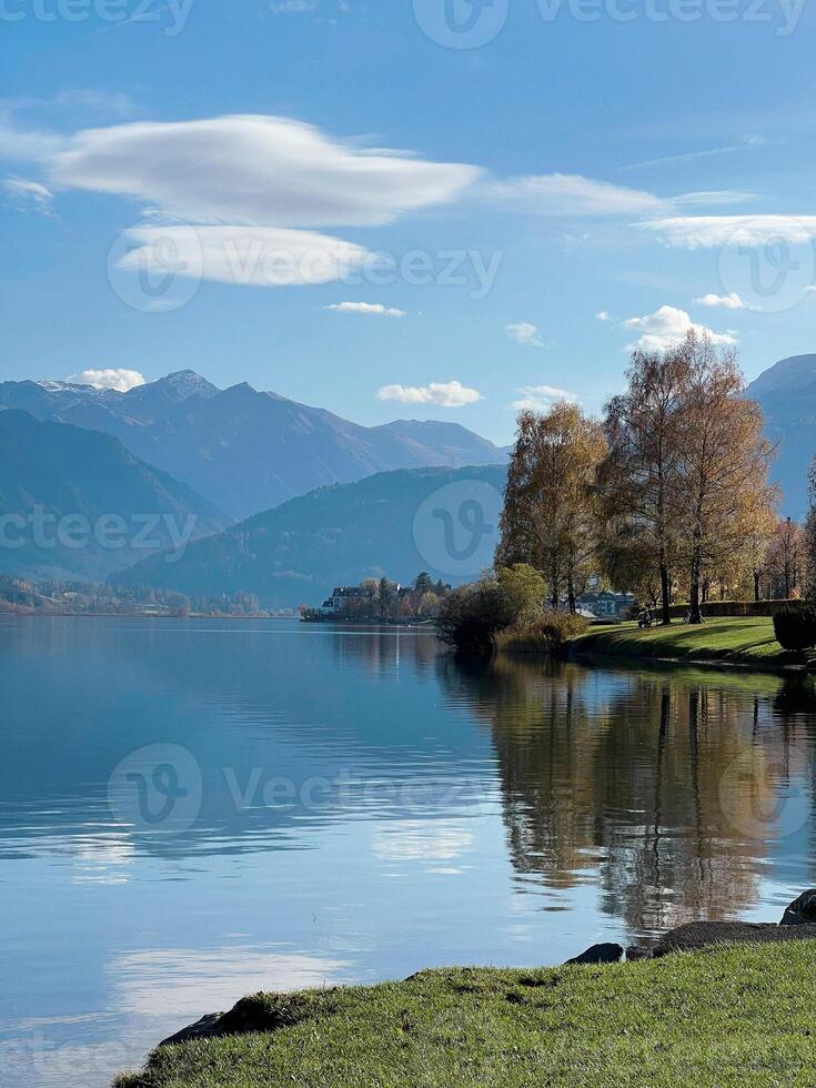 Beautiful view of Zell am See lake in Austria. Green landscape at the background Alps mountains photo