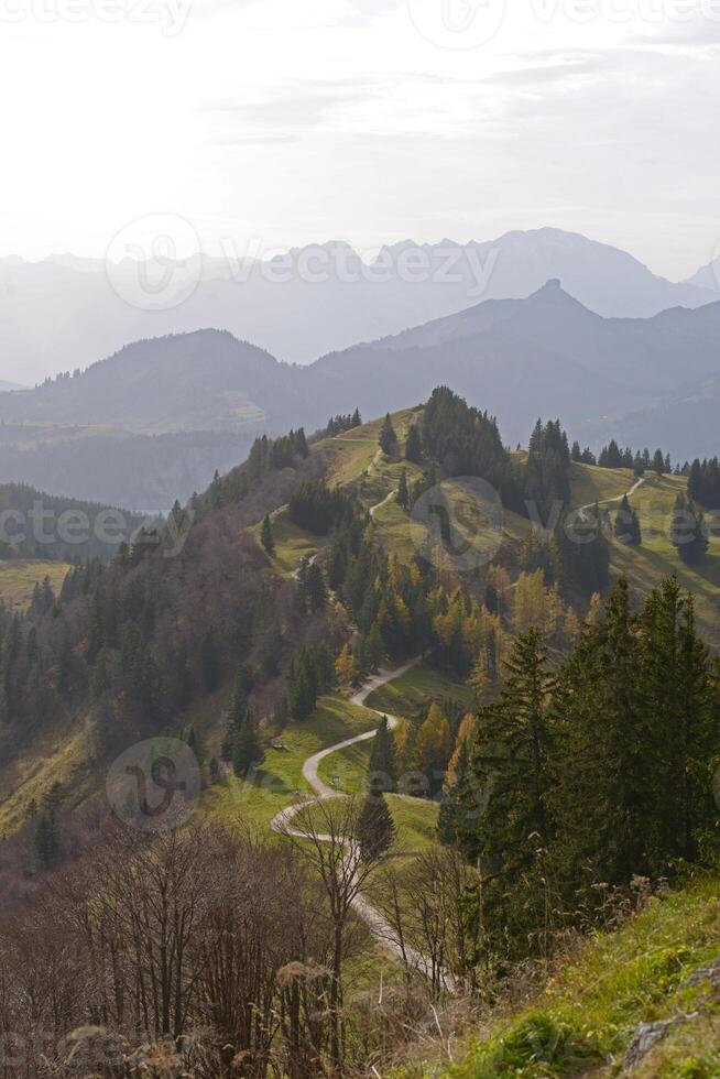 Autumn Alpine mountain landscape. Scenic walking path on the Zwolferhorn peak in Sankt Gilgen, Austria photo
