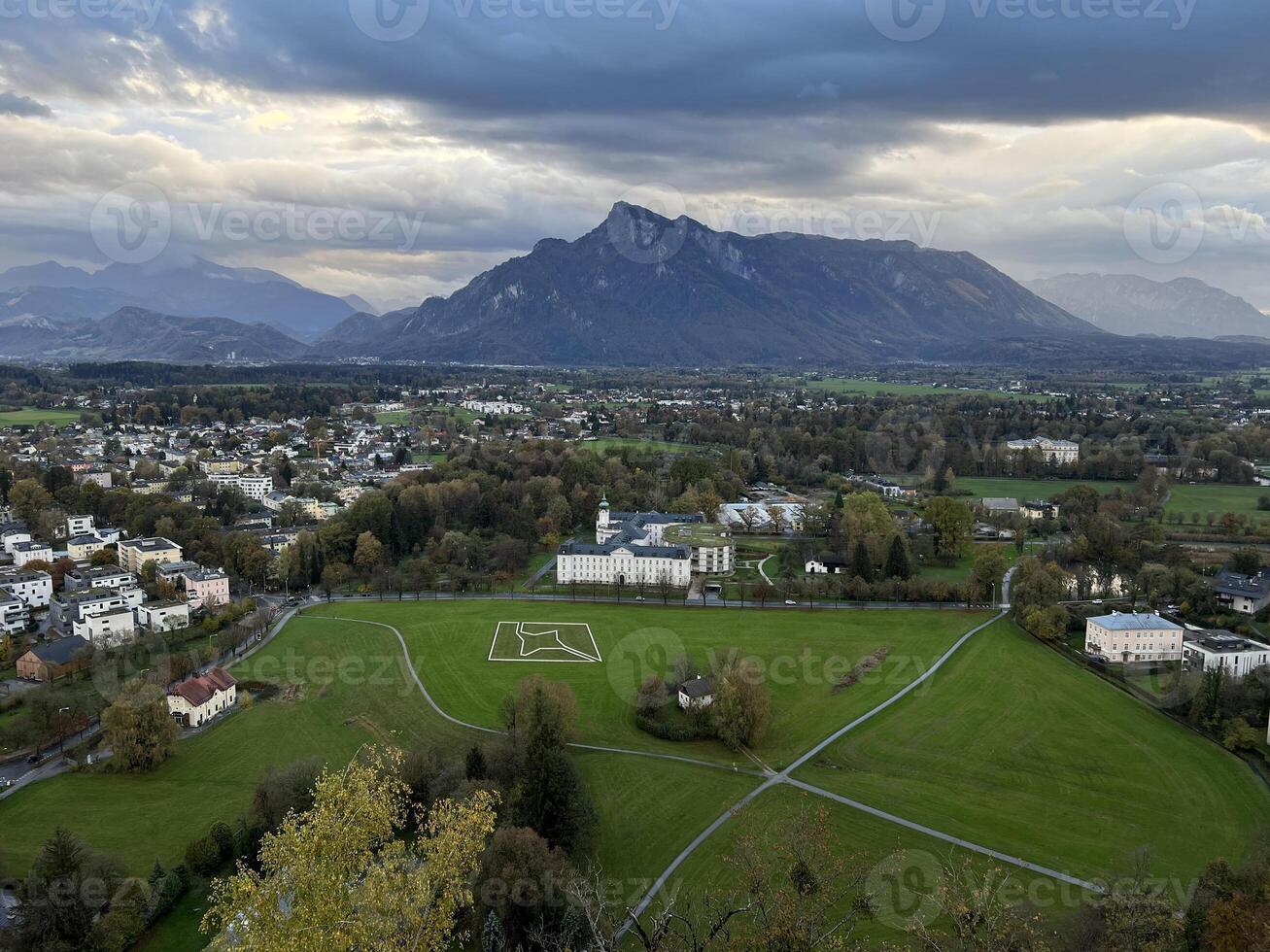 Panoramic view of Salzburg with mountains at the background in the evening at sunset photo