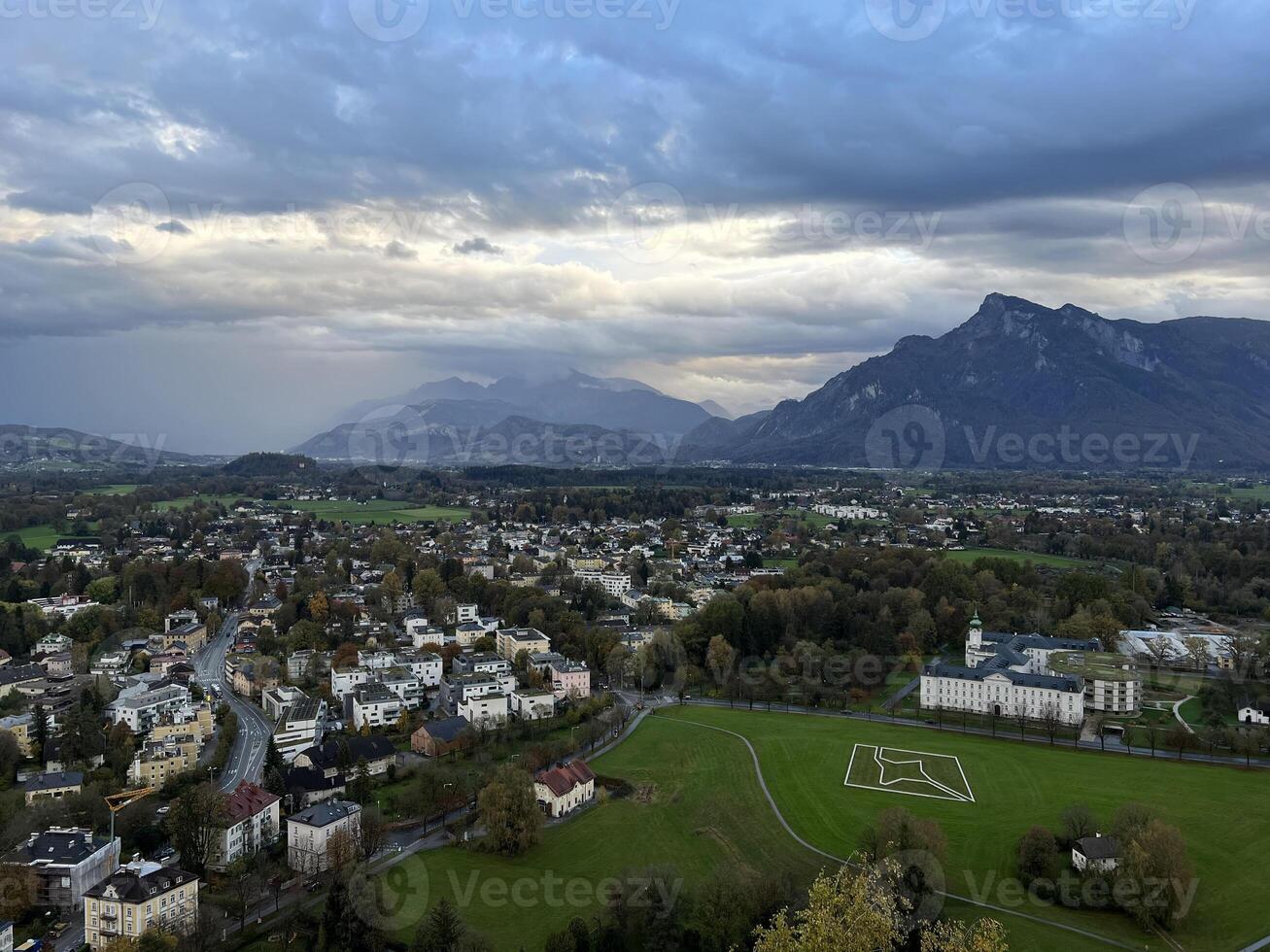 Panoramic view of Salzburg with mountains at the background in the evening at sunset photo