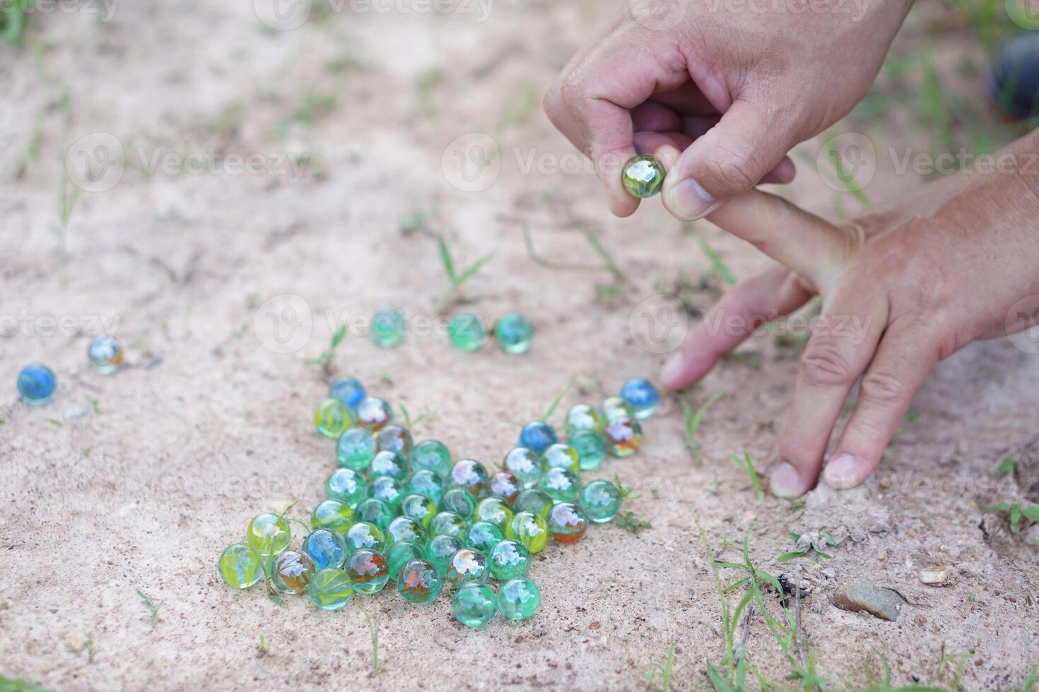 Closeup hand holds round small marble balls to play games. Concept traditional childen play toy. Recreation activity to make concentrate for kids fun and competition games 49897936 Stock Photo at Vect...