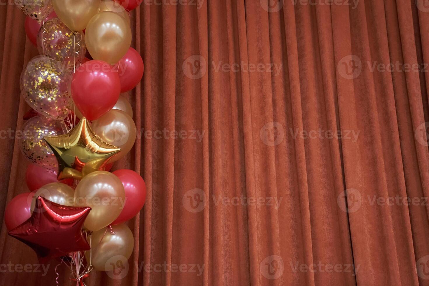 Orange closed curtain or drapery in theater with multicolored balloons with copy space. Theatrical performance concept. photo