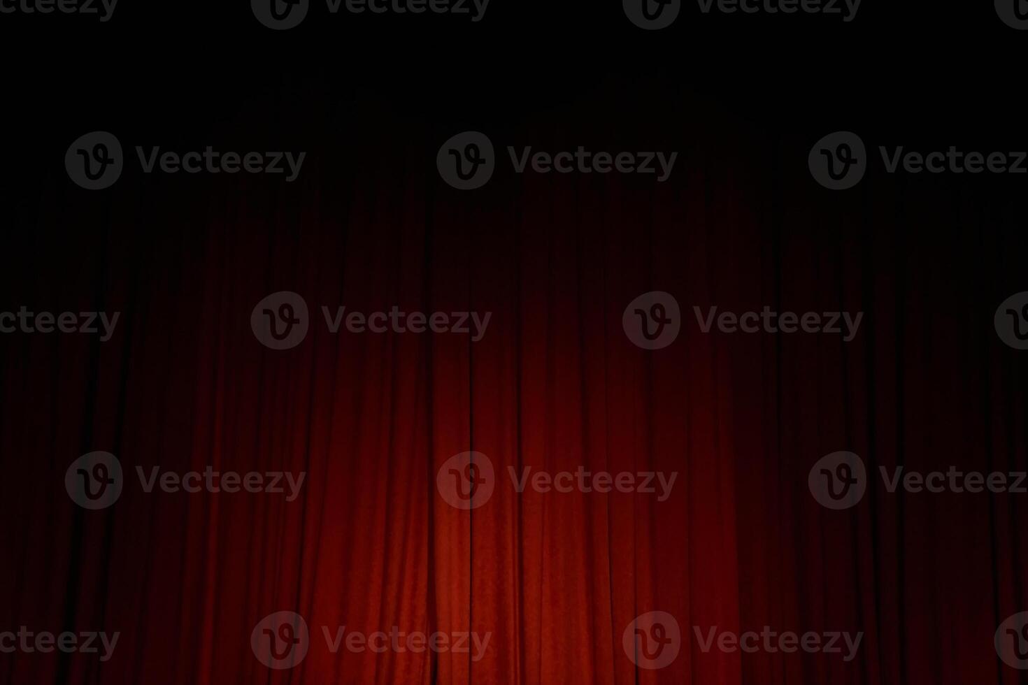 Spot light on the red closed curtain or drapes on stage in theater with copy space. Theatrical performance concept photo