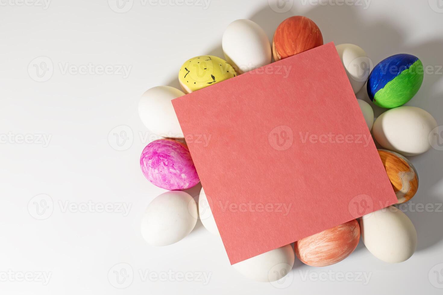 Colorful easter eggs with blank red card on white background. photo